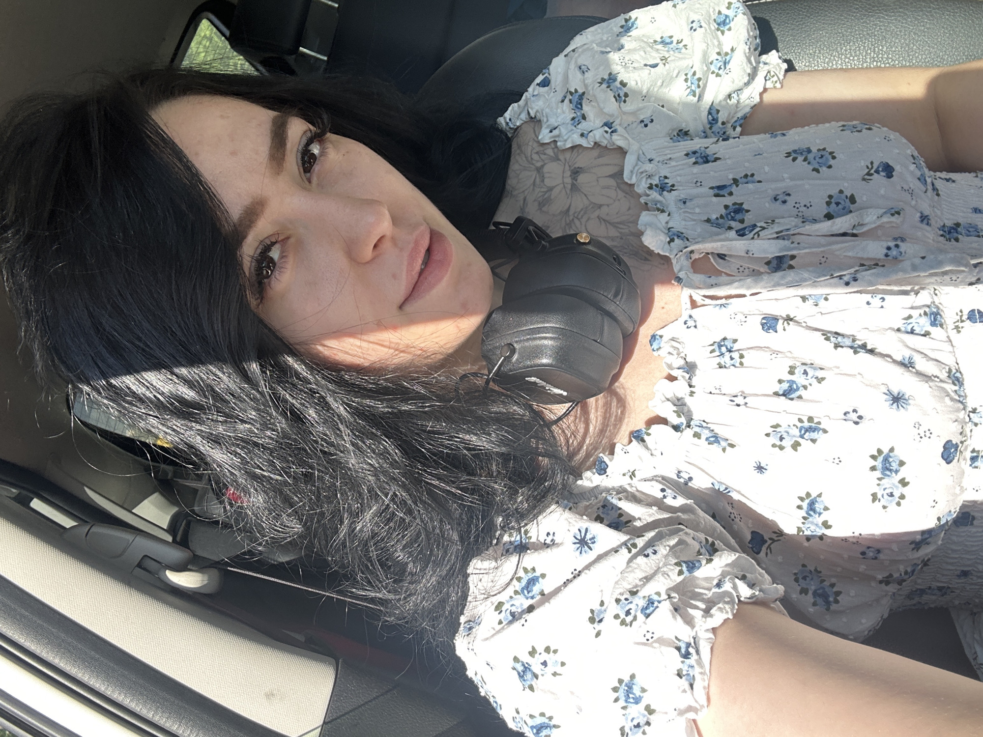 Woman reclining in vehicle with headphones observed in Izhevsk