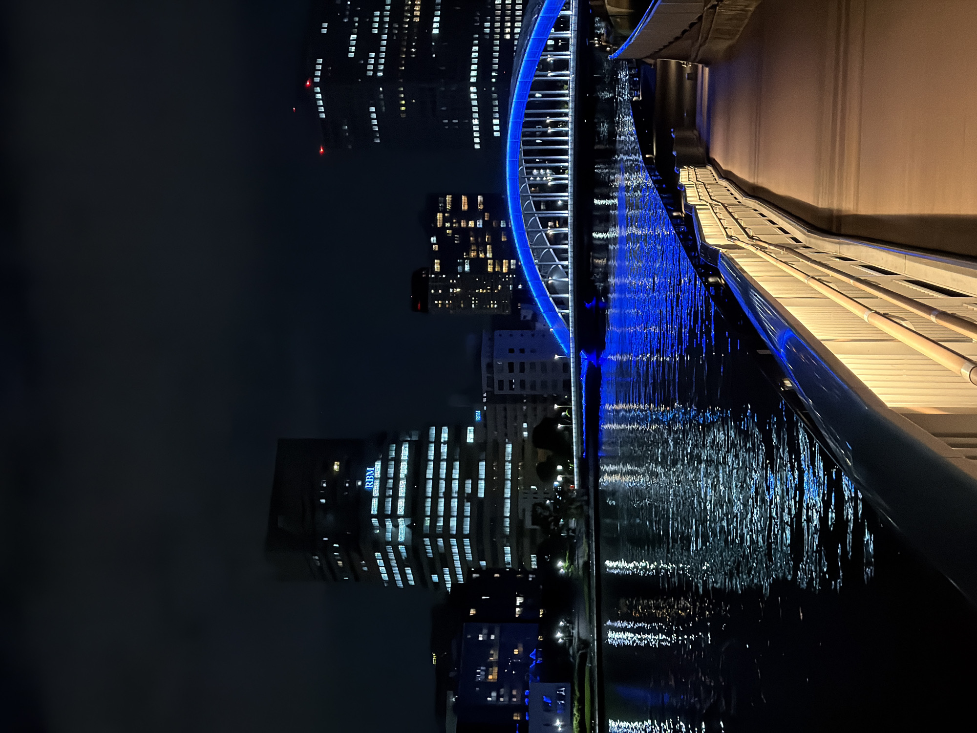 Illuminated bridge observed over Koto river amid city skyline