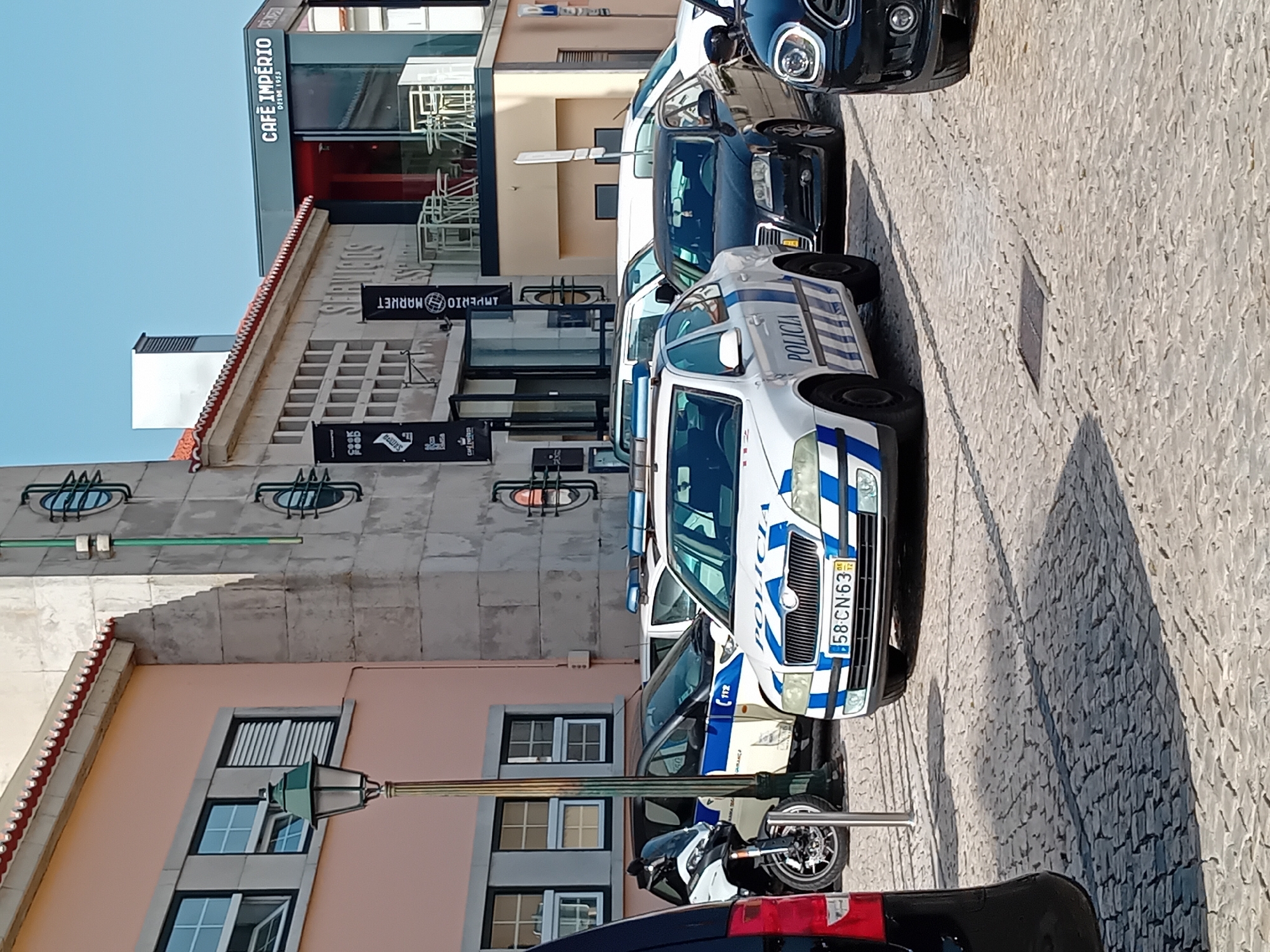 Police presence observed on palm-lined streets in Cascais