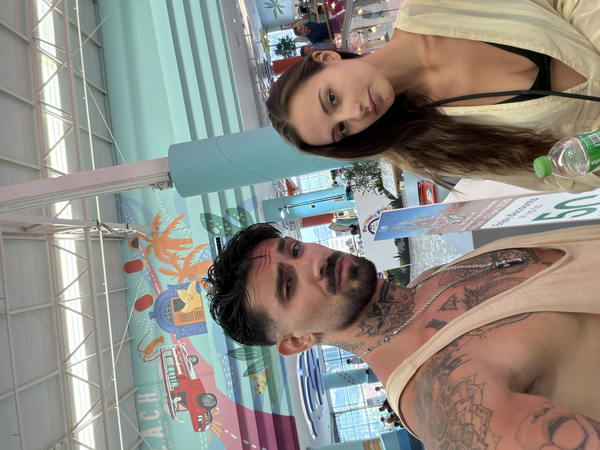 Couple Takes Indoor Selfie Against Mural in Thailand