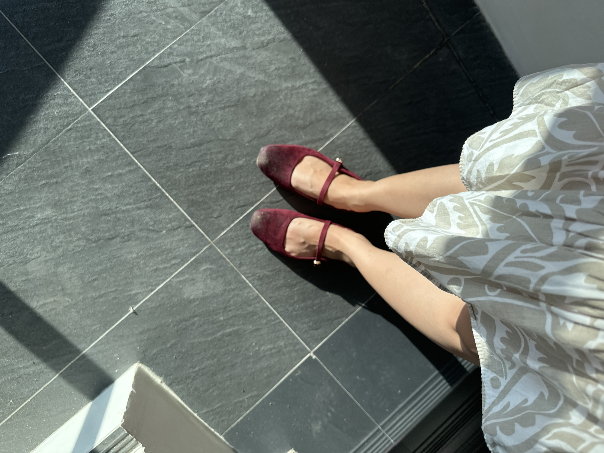 Person in burgundy shoes walks up stairs in Davao