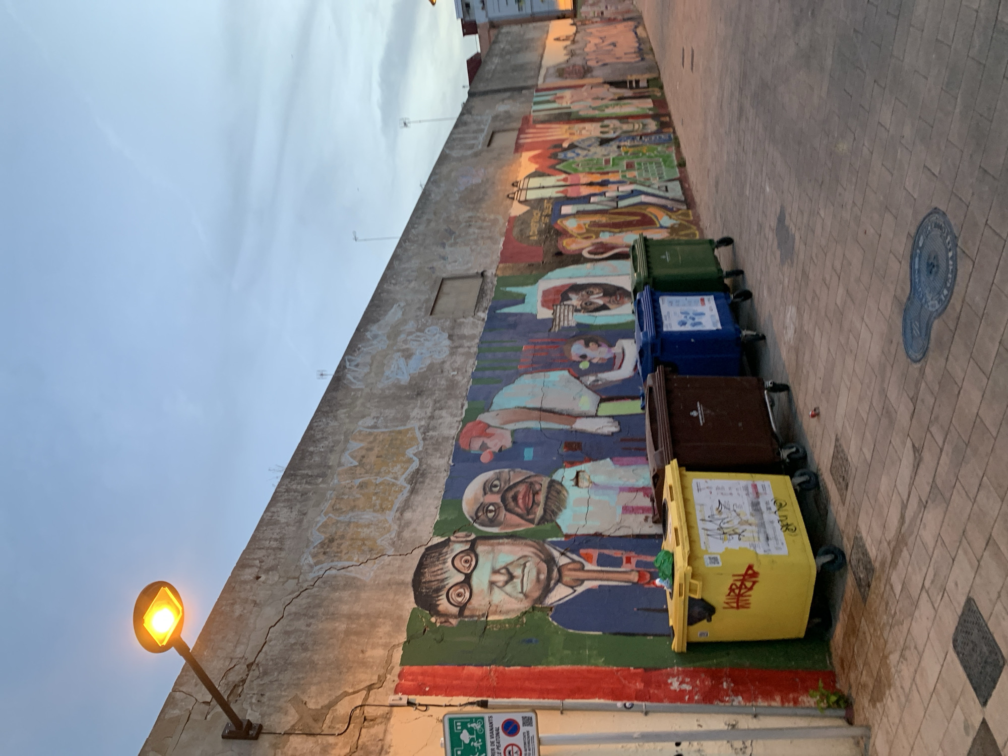 Valencia's street art scene at dusk, murals and graffiti throughout.