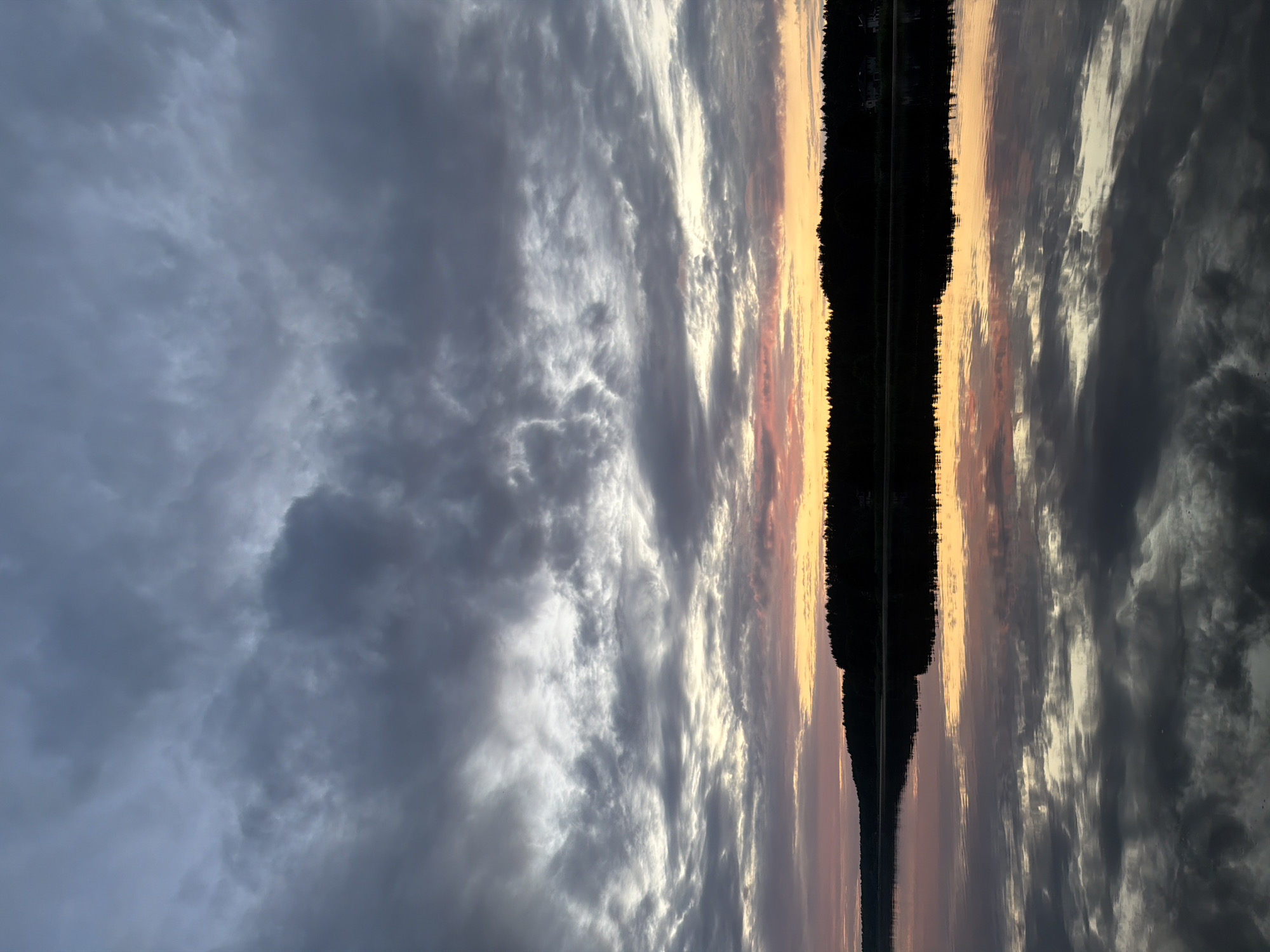 Dramatic summer sunset over a calm lake in Varkaļi
