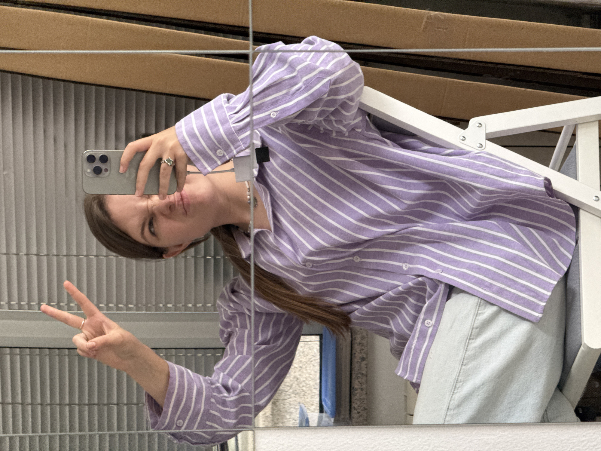 Person makes peace sign in mirror selfie in Belgrade