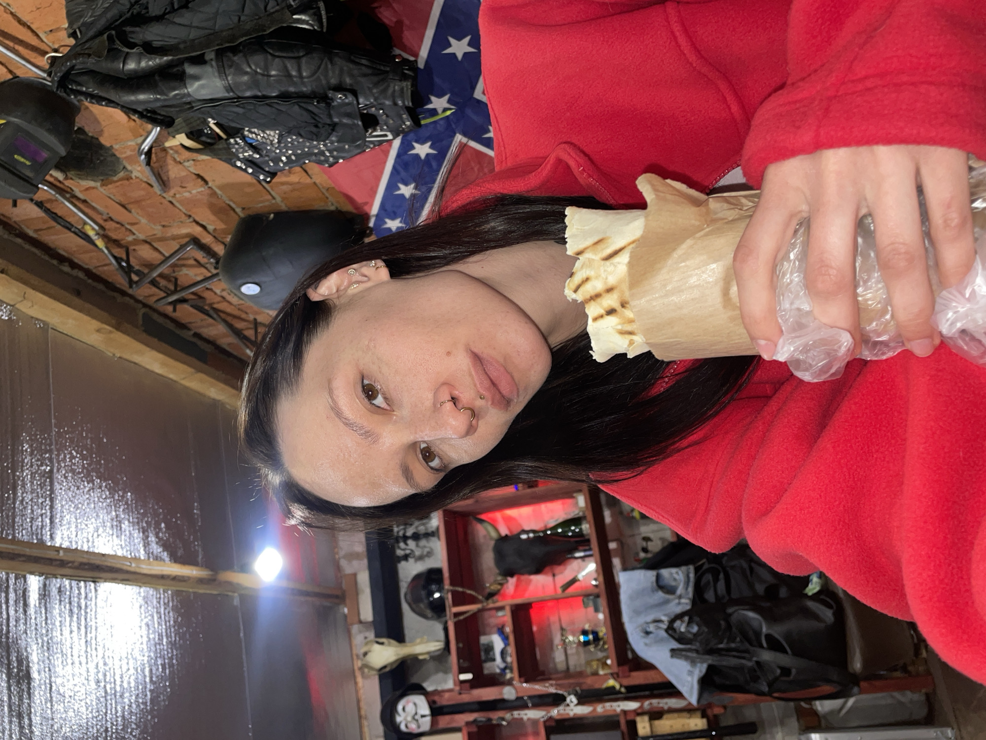Woman eats kebab wrap in Oktyabr'skii, Russia