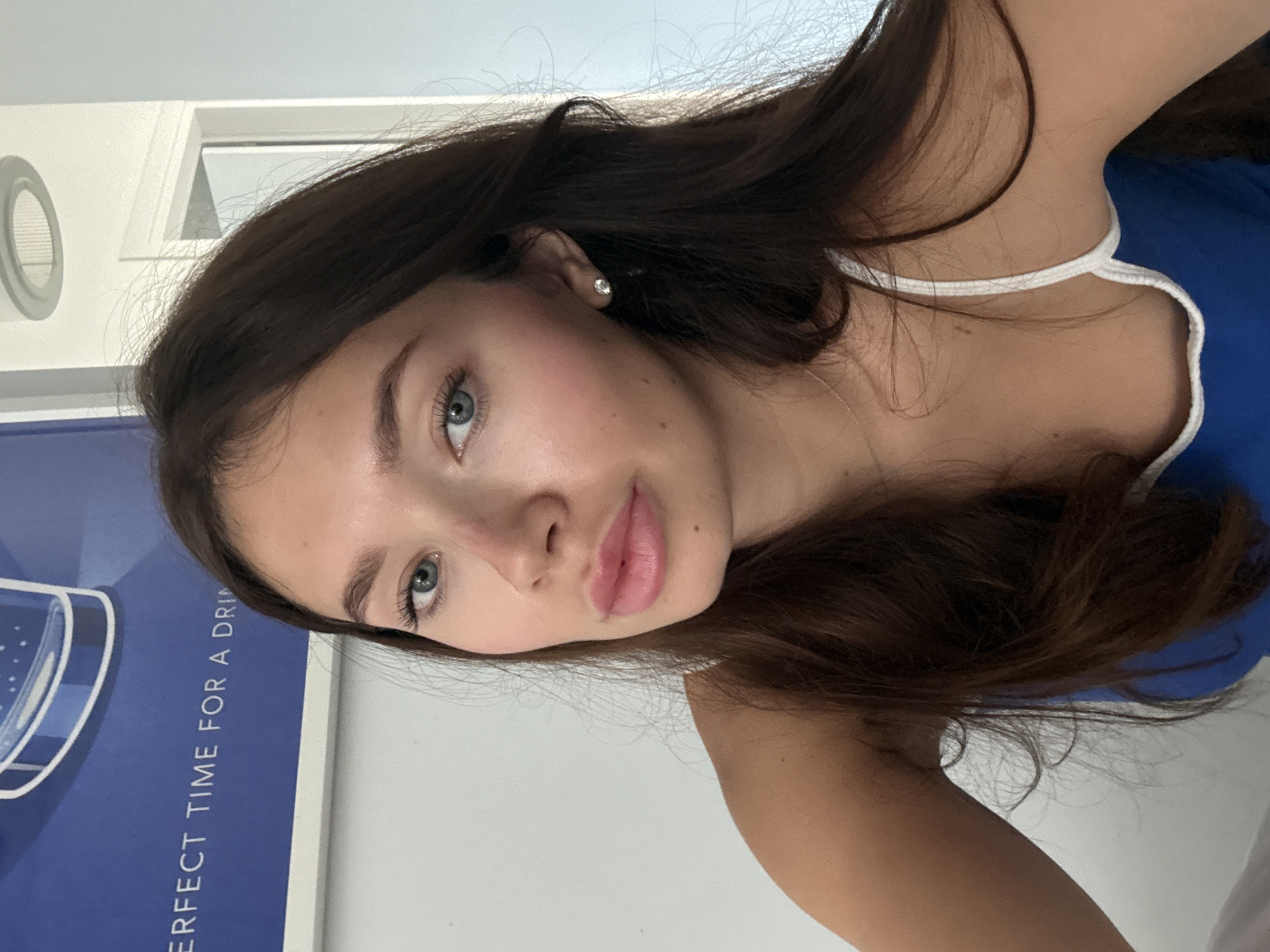 Woman takes multiple selfies indoors in Livadia Larnakas, Cyprus