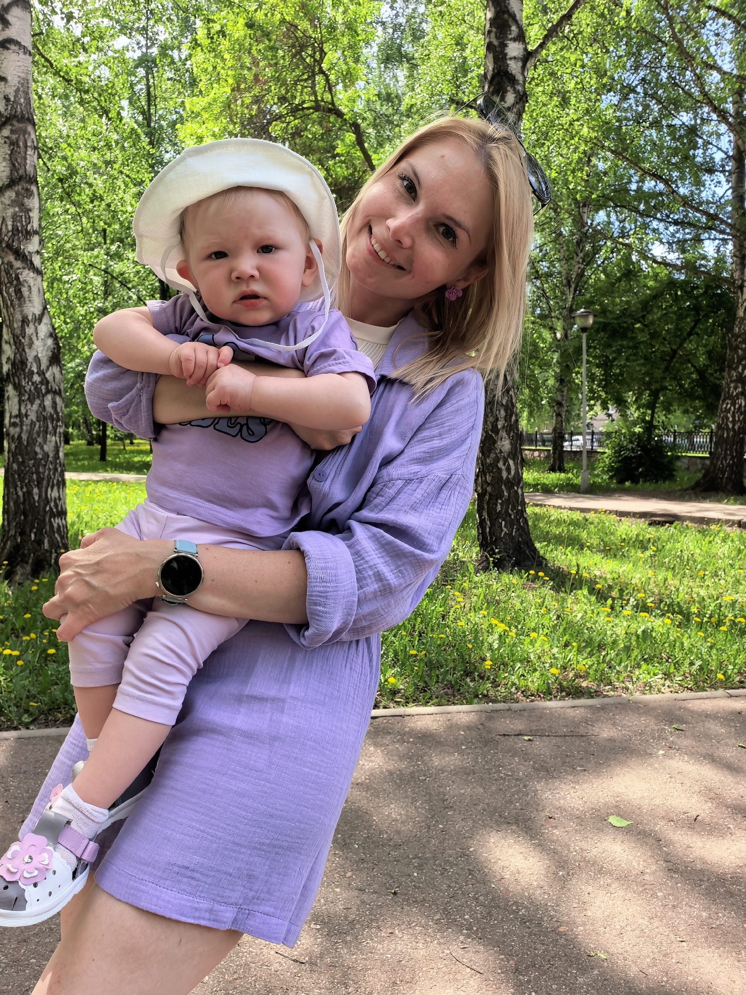 Woman with baby enjoys morning park visit in Sterlitamak
