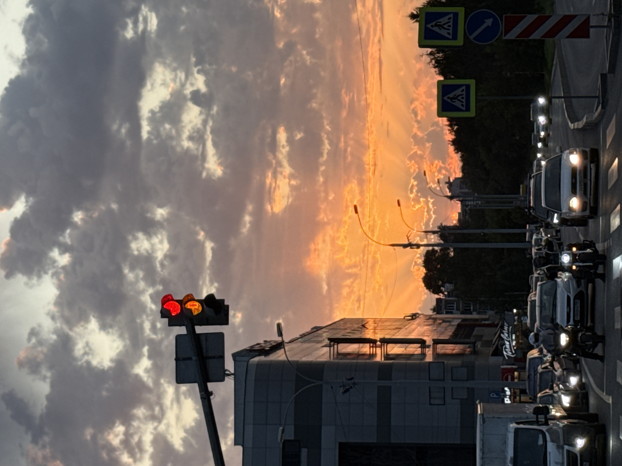 Dramatic sunset over Yekaterinburg streets, clouds lit in orange and pink