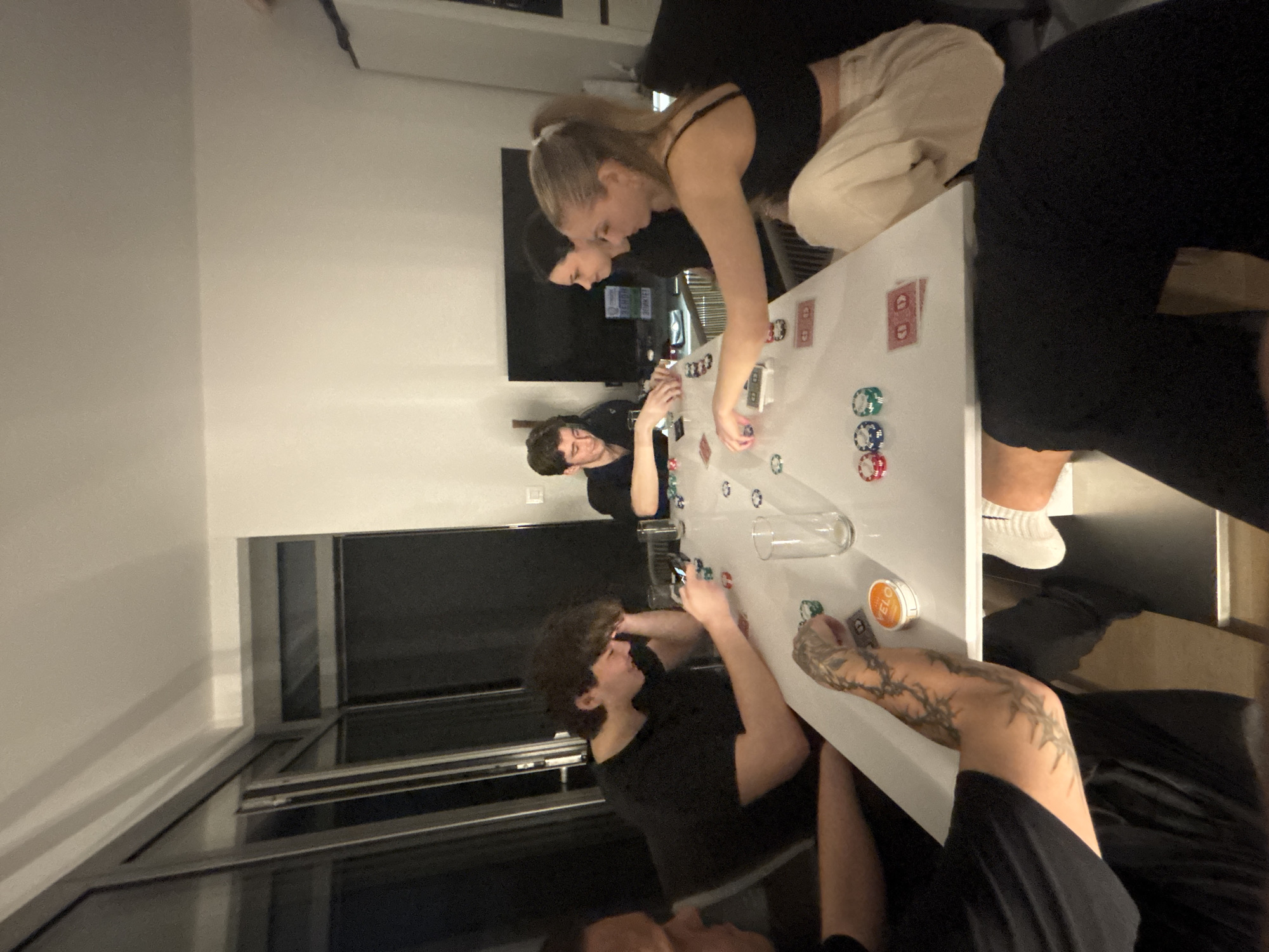 Young adults play poker in Bratislava apartment
