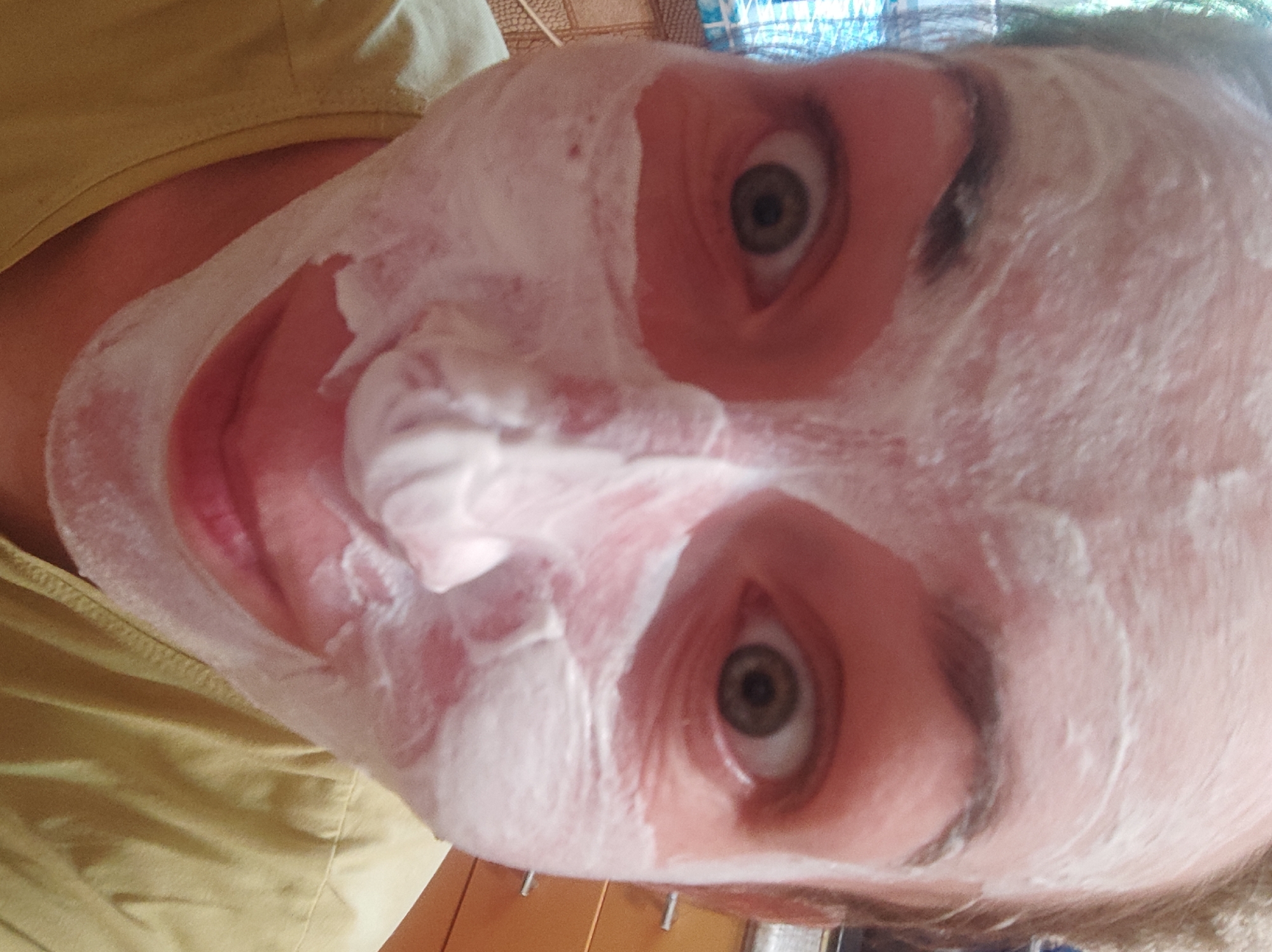 Person applies white facial mask in Smolensk selfie
