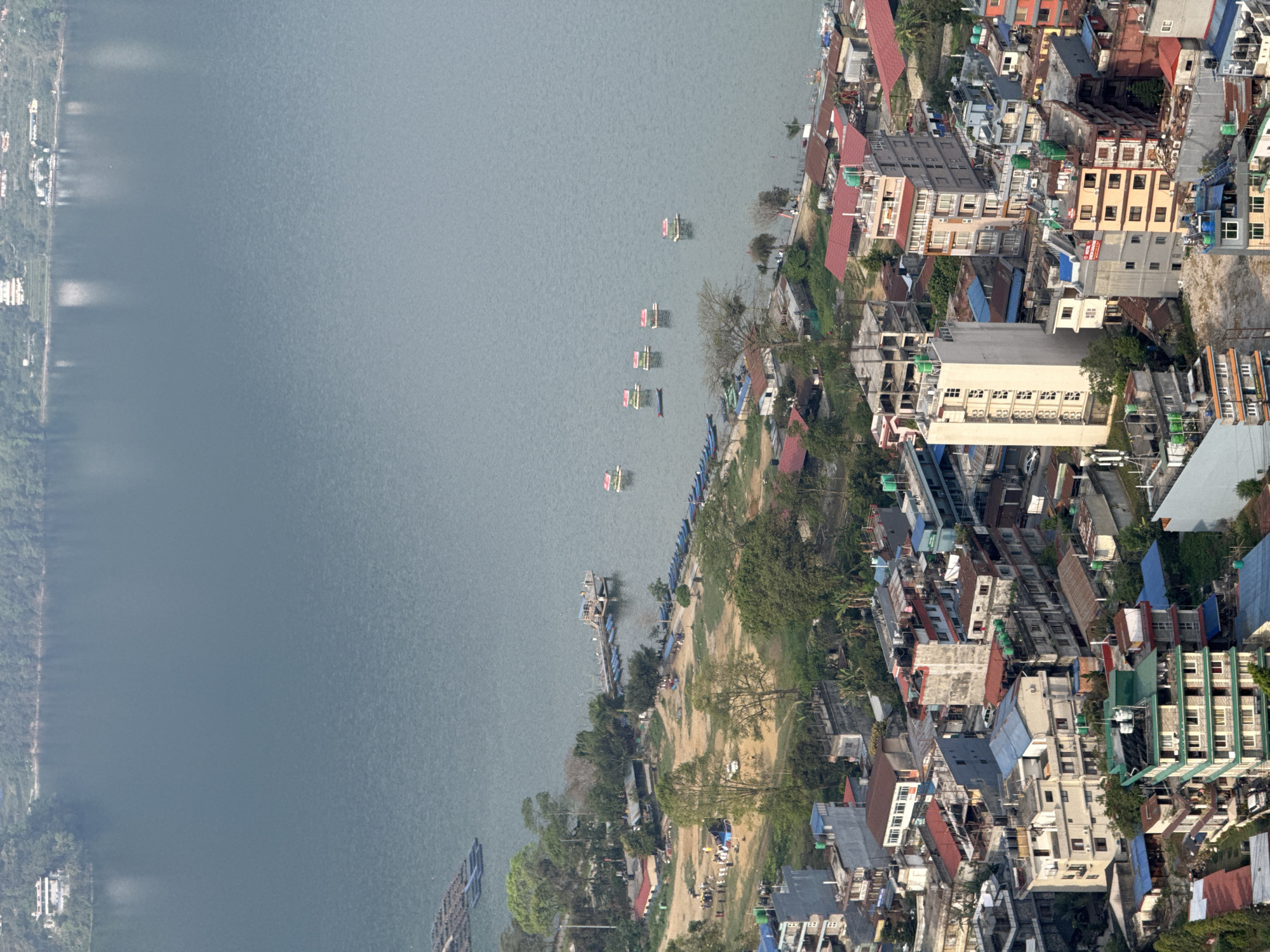 Small yellow plane flies over Pokhara Nepal early morning