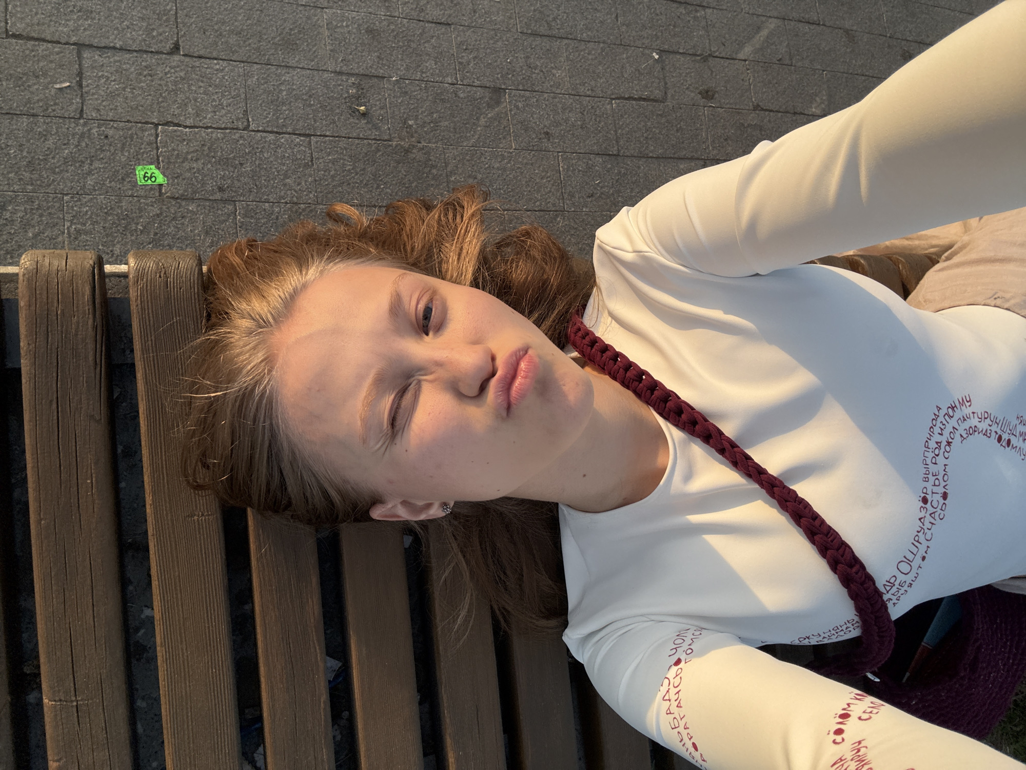 Woman rests on park bench in Perm, Russia