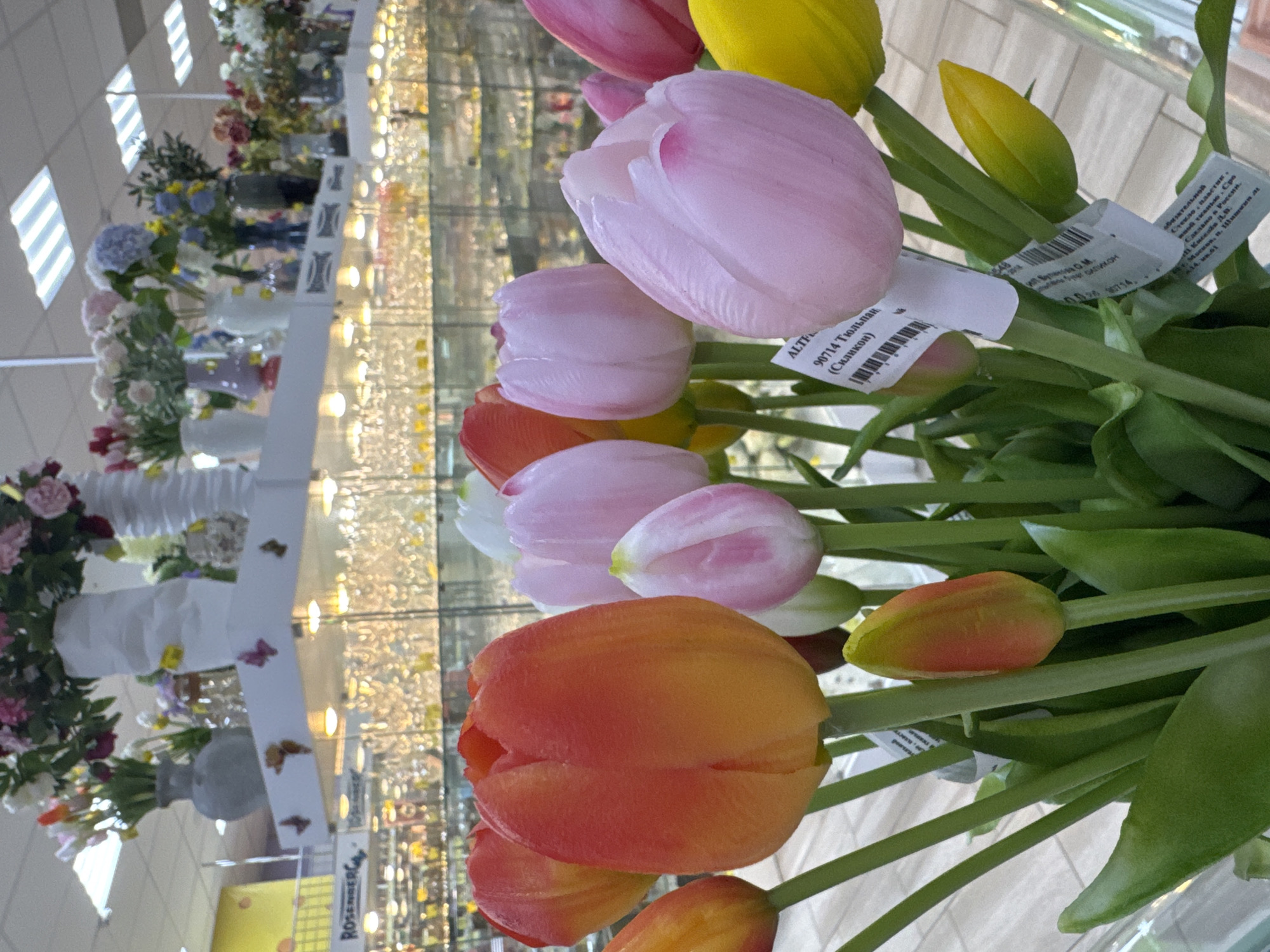 Woman shops for artificial tulips at Klin market