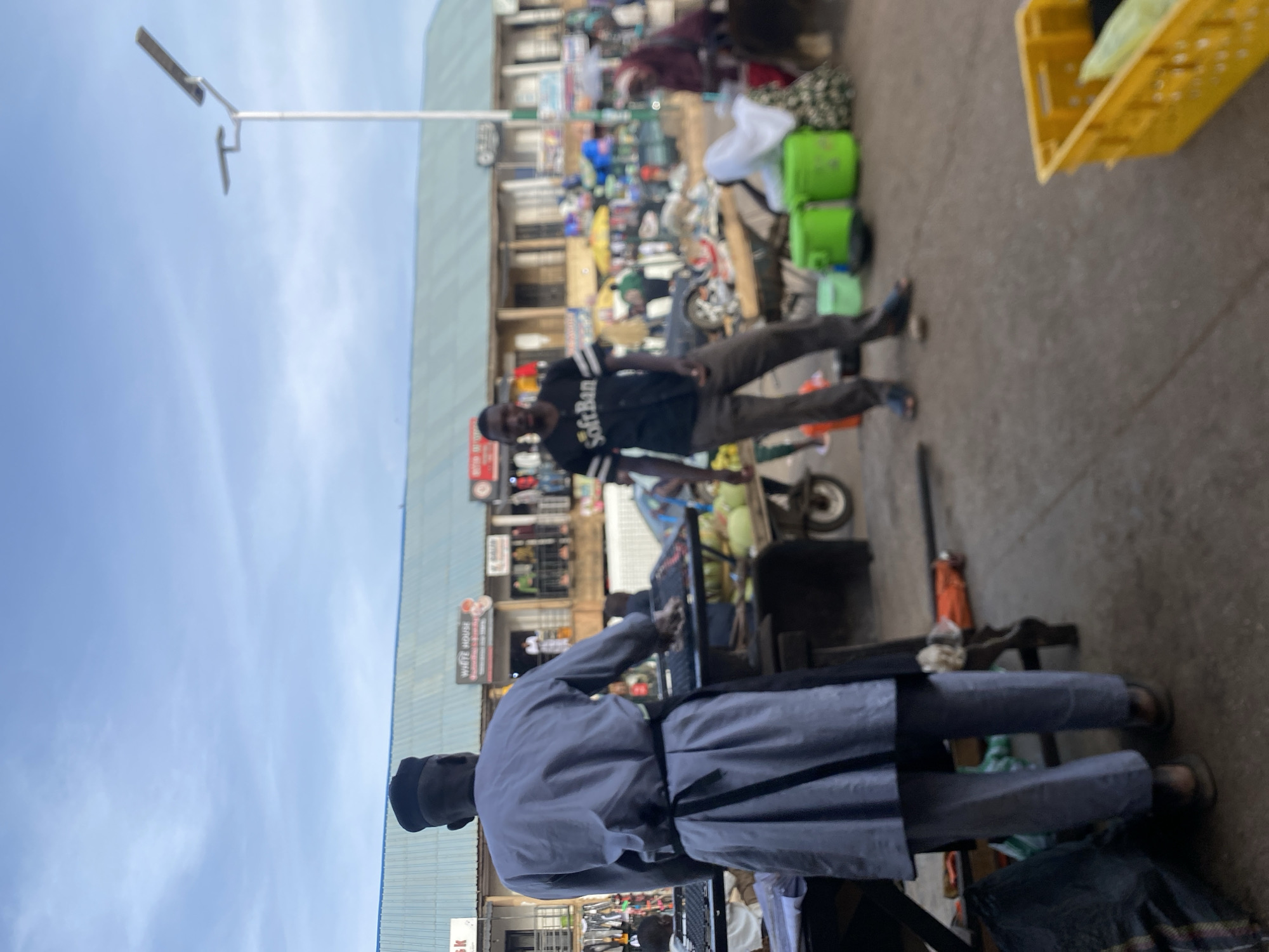 Daily life unfolds in Bukuru Nigeria marketplace during afternoon