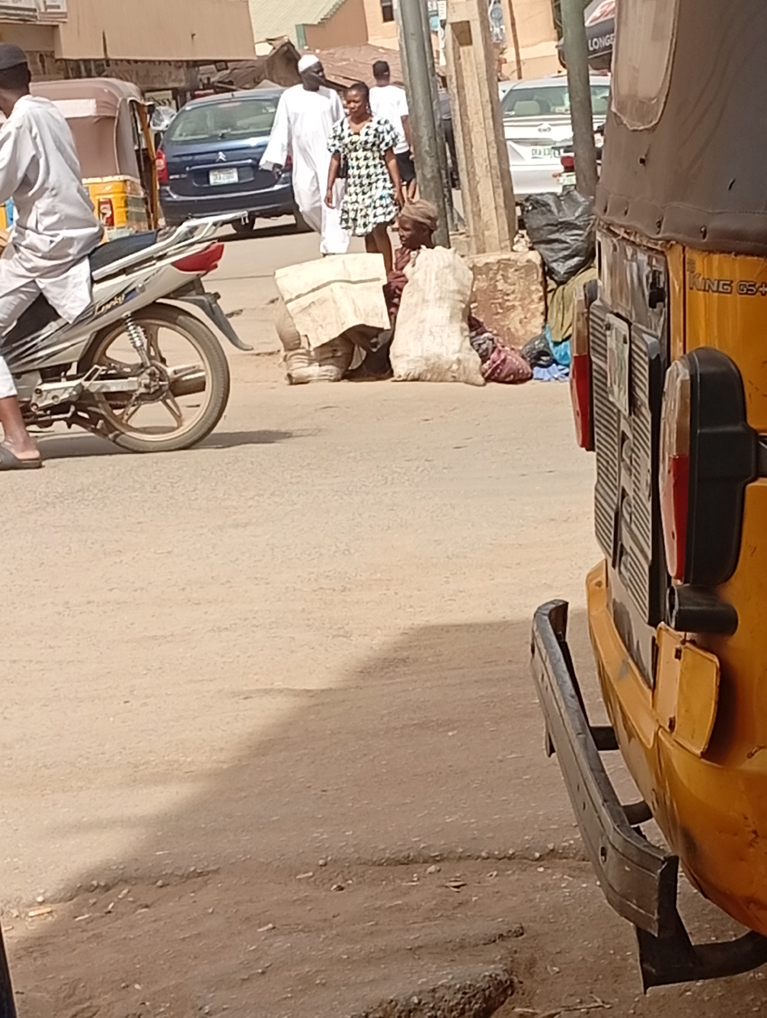 Street scene with motorcycle riders captured in Maiburiji, Nigeria