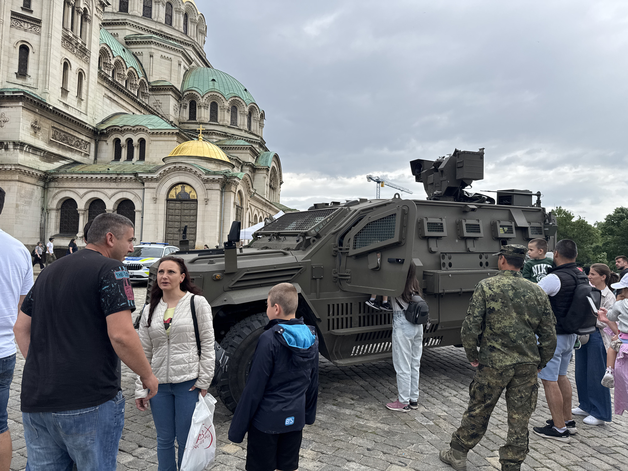 Military vehicles gather at Sofia cathedral amid crowds