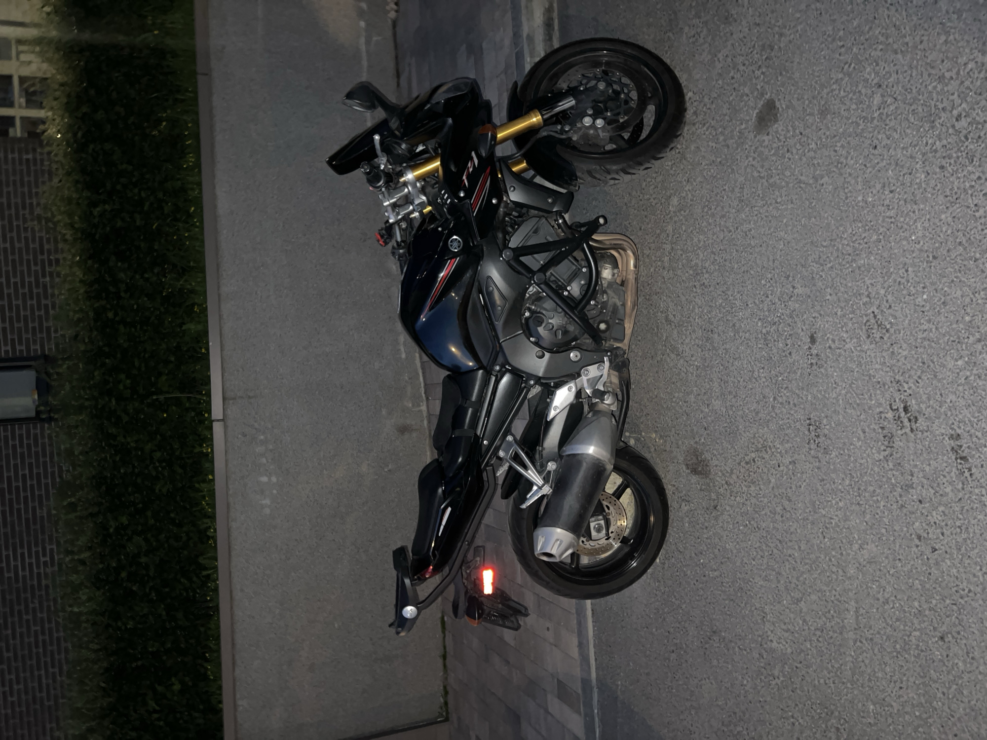 Evening street documentation captures motorcycle, buildings in Russian city