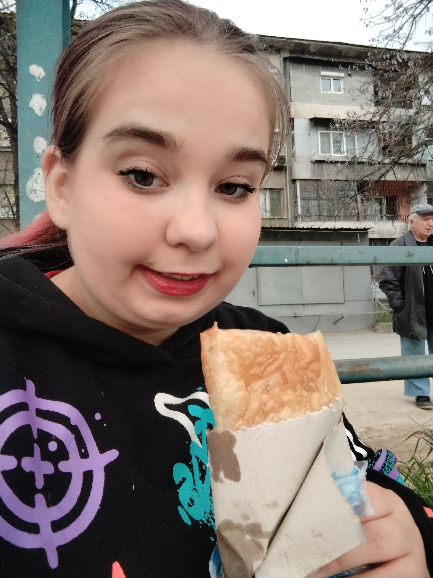 Woman enjoys traditional burek breakfast in Plovdiv, Bulgaria
