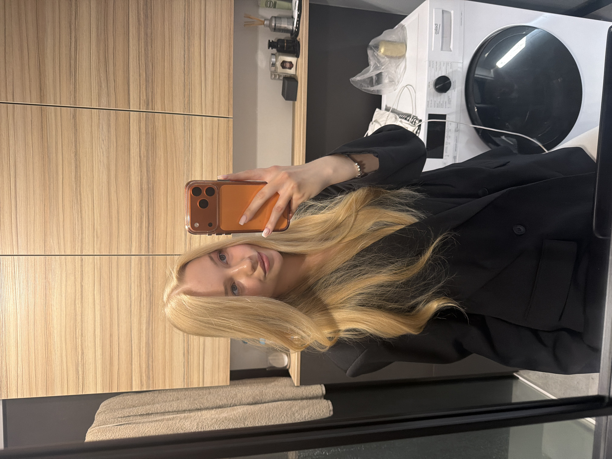 Woman Takes Multiple Bathroom Selfies with Orange Phone