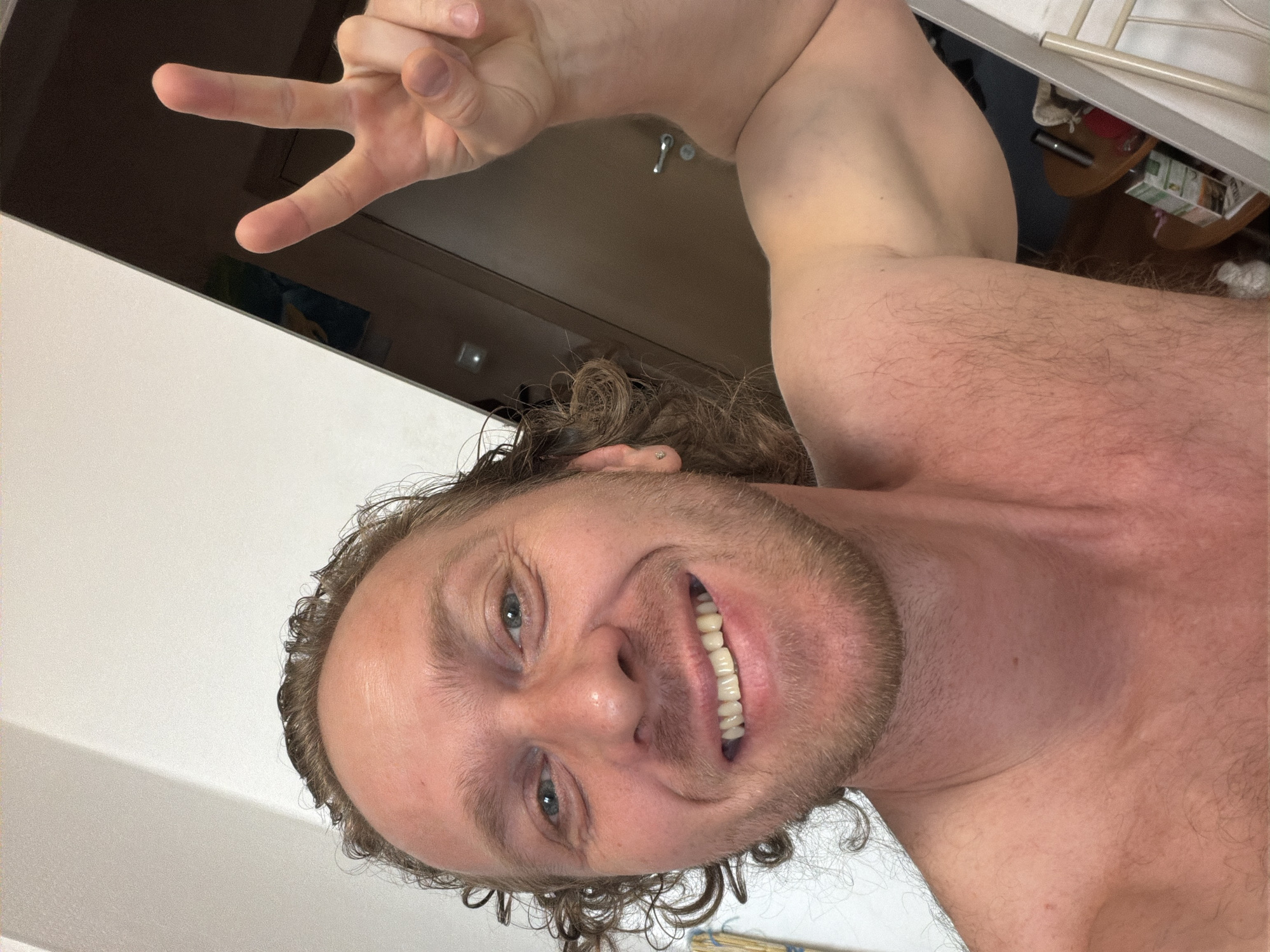 Man takes smiling selfie with peace sign in Saint Petersburg