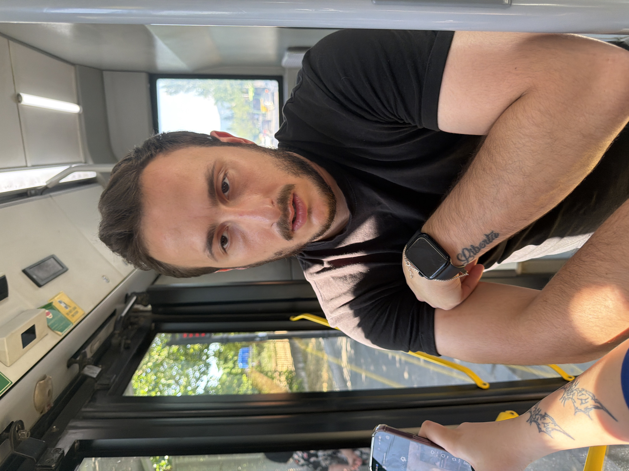 On a Tbilisi bus, a passenger and a bilingual window sign