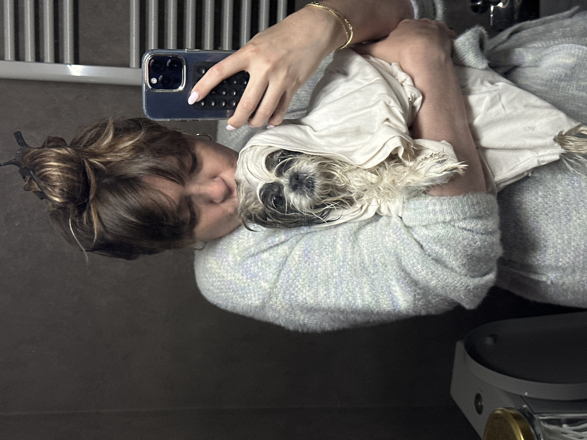 Pet grooming session documented in Tbilisi apartment bathroom