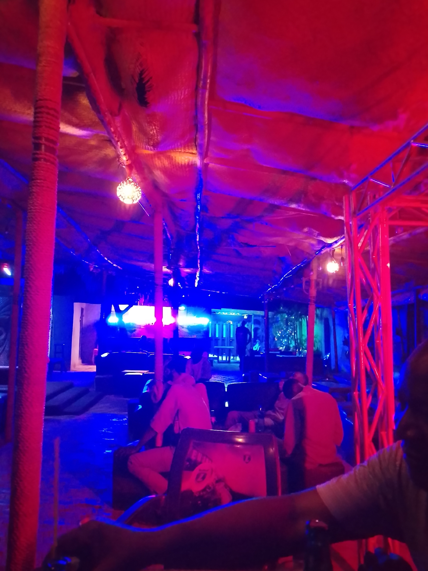 Evening gathering at atmospheric bar with distinctive lighting