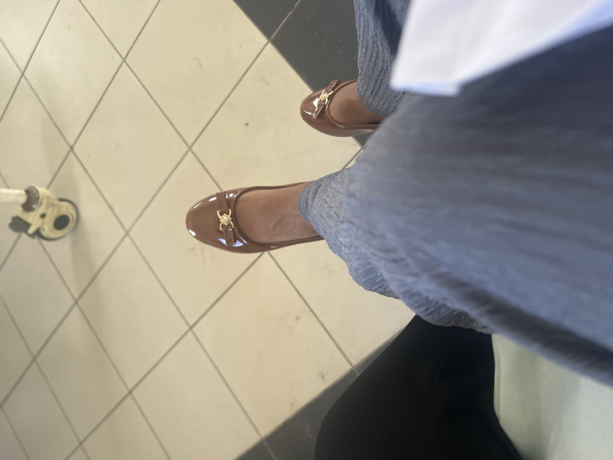 Person in ballet flats sits near medical device in Tanzania