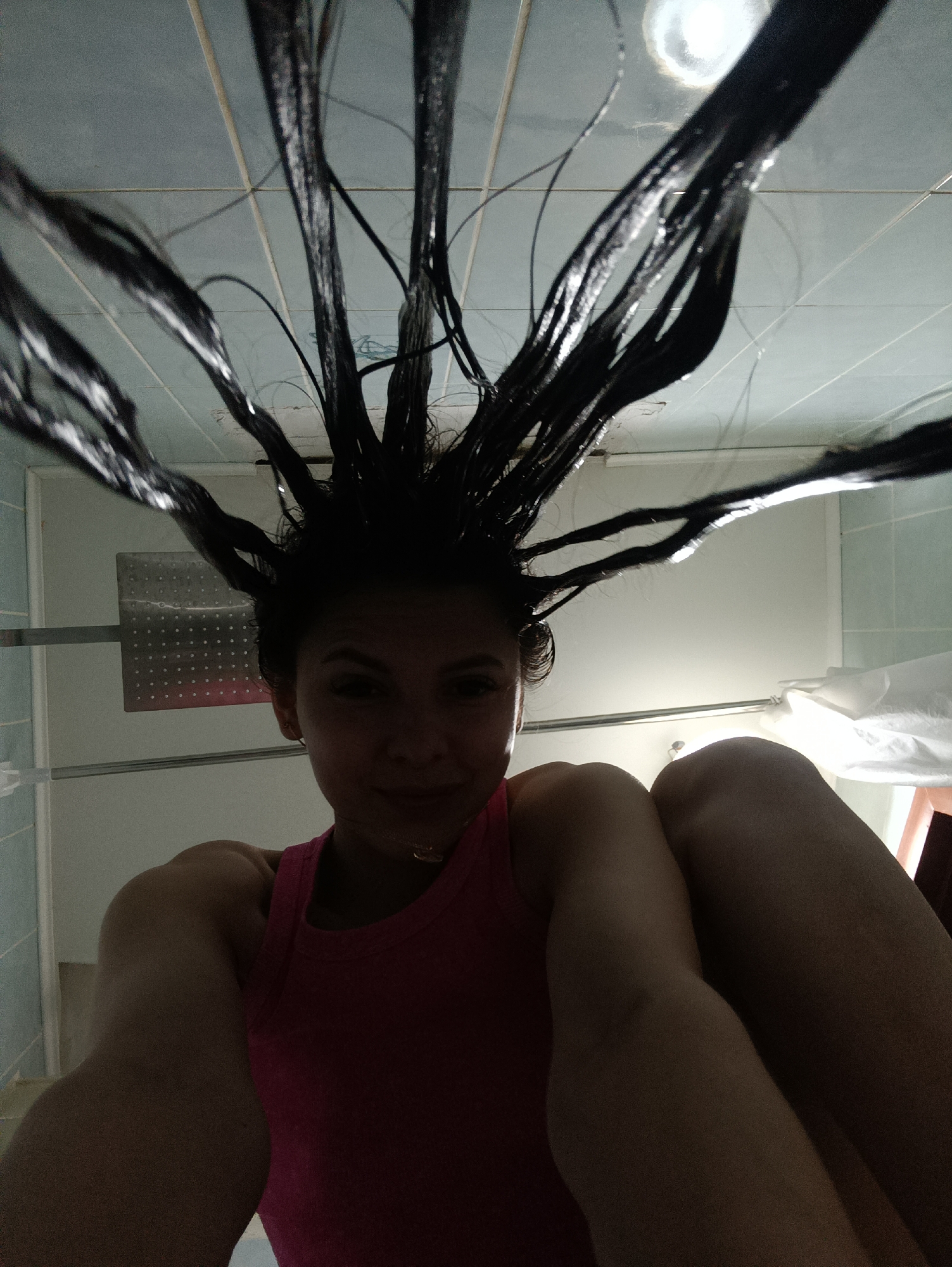Woman with wet hair recorded in bathroom setting