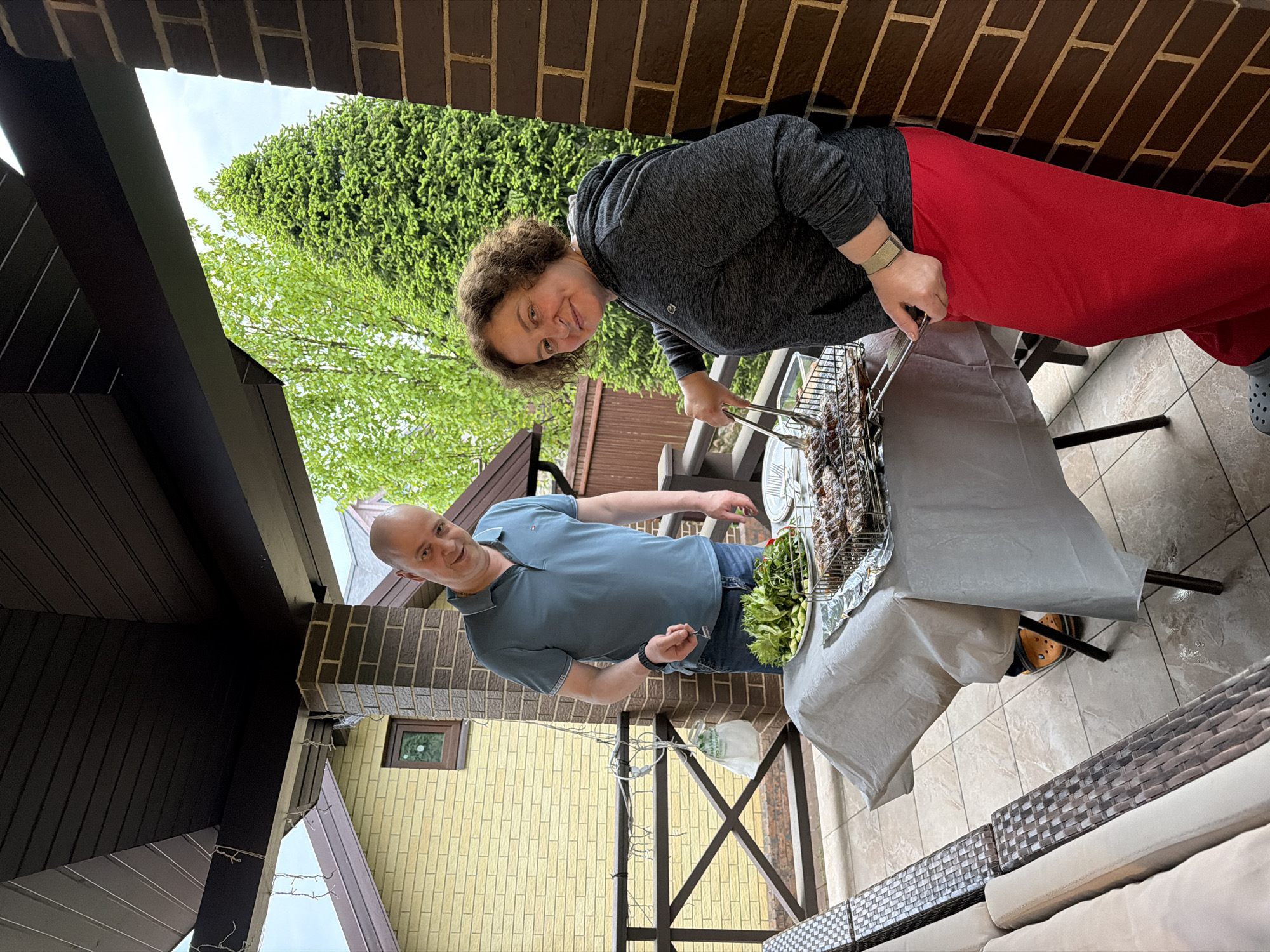 Rain-soaked backyard barbecue gathering documented in suburban Russia
