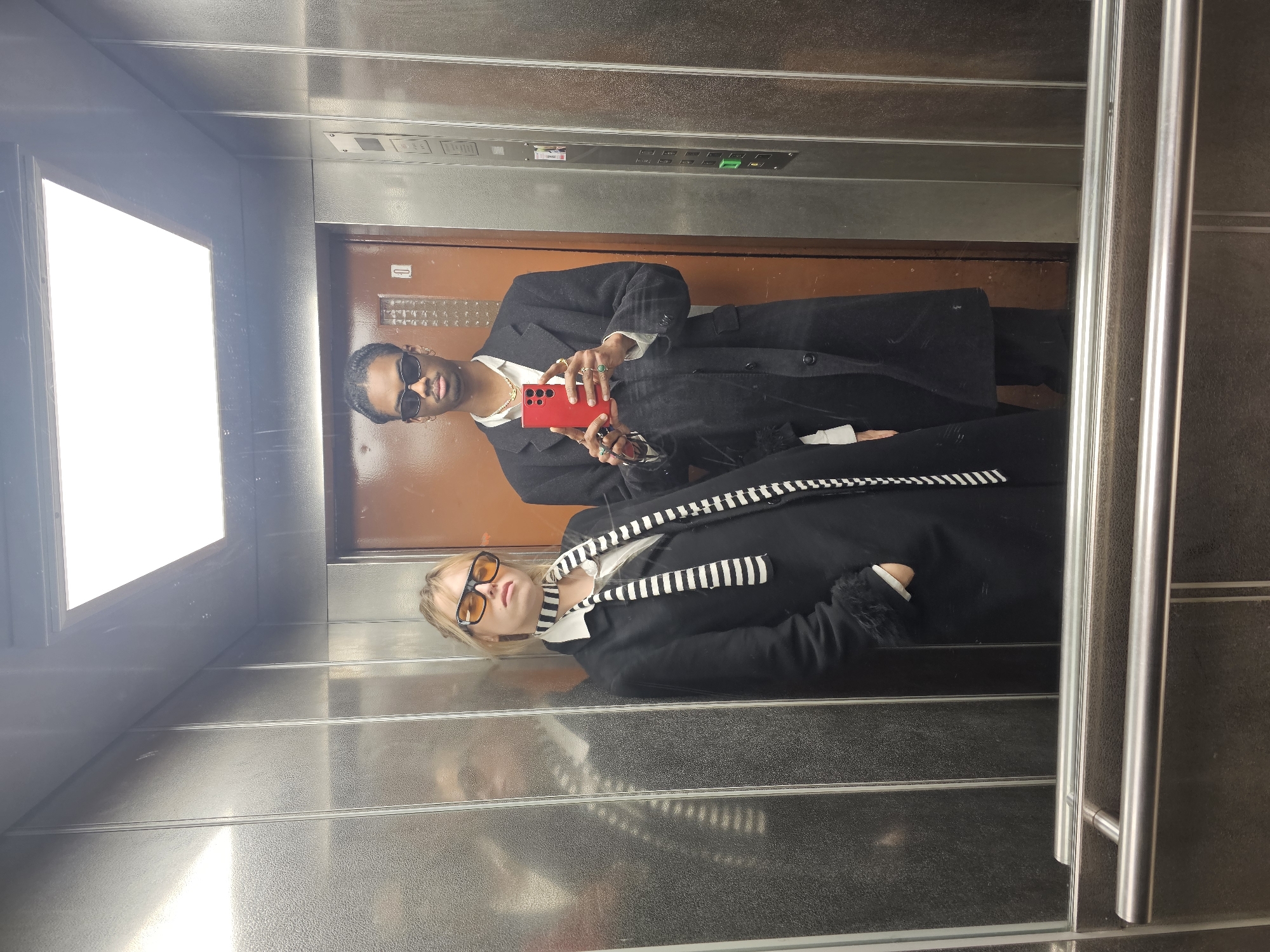 Two people spotted in elevator reflection in Pantin