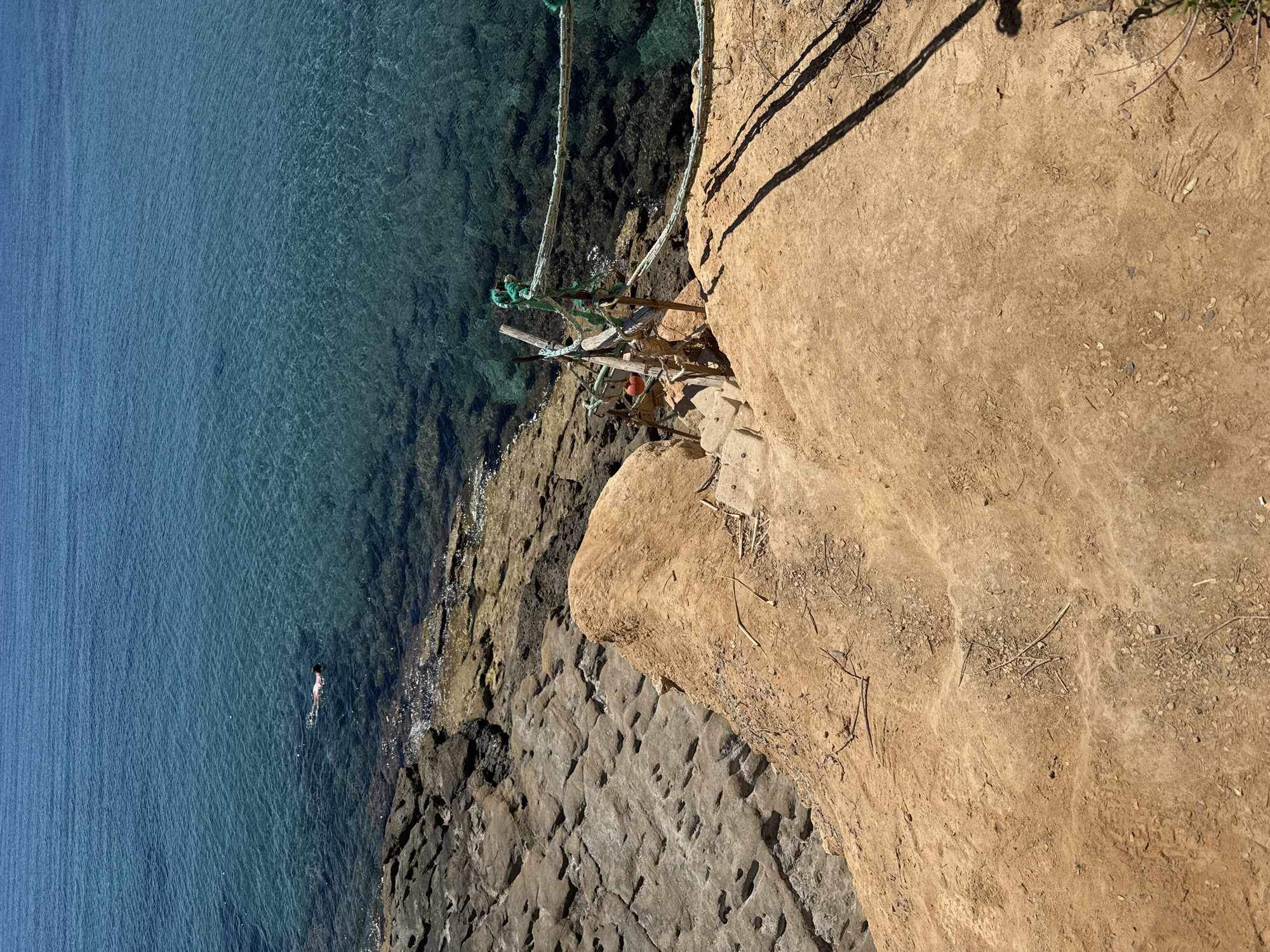 Aerial view of Crete's turquoise coastline and cliffside