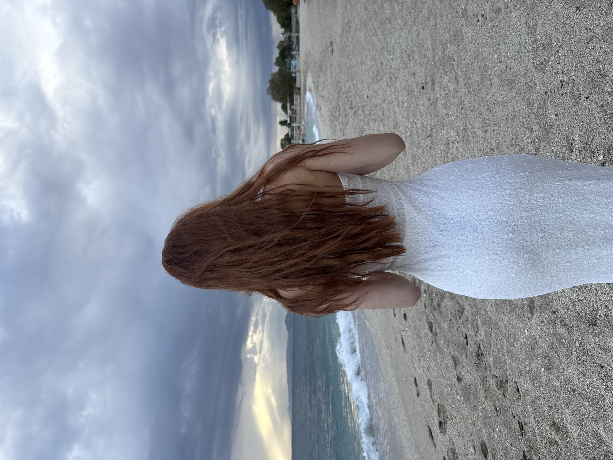 Woman in white dress spotted on overcast Alimos beach