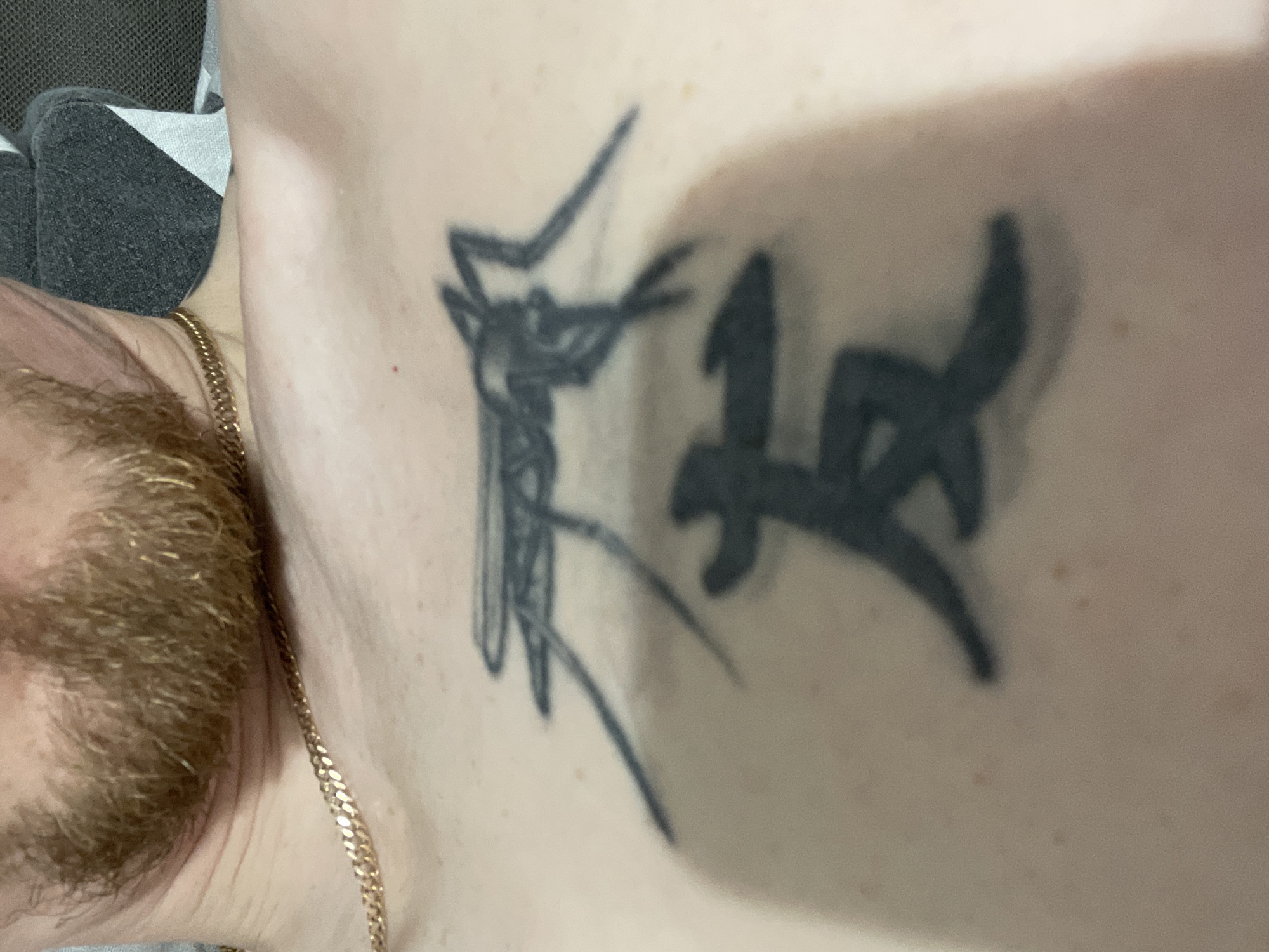 Bearded man photographed in bedroom showing climbing tattoo, Sarapul