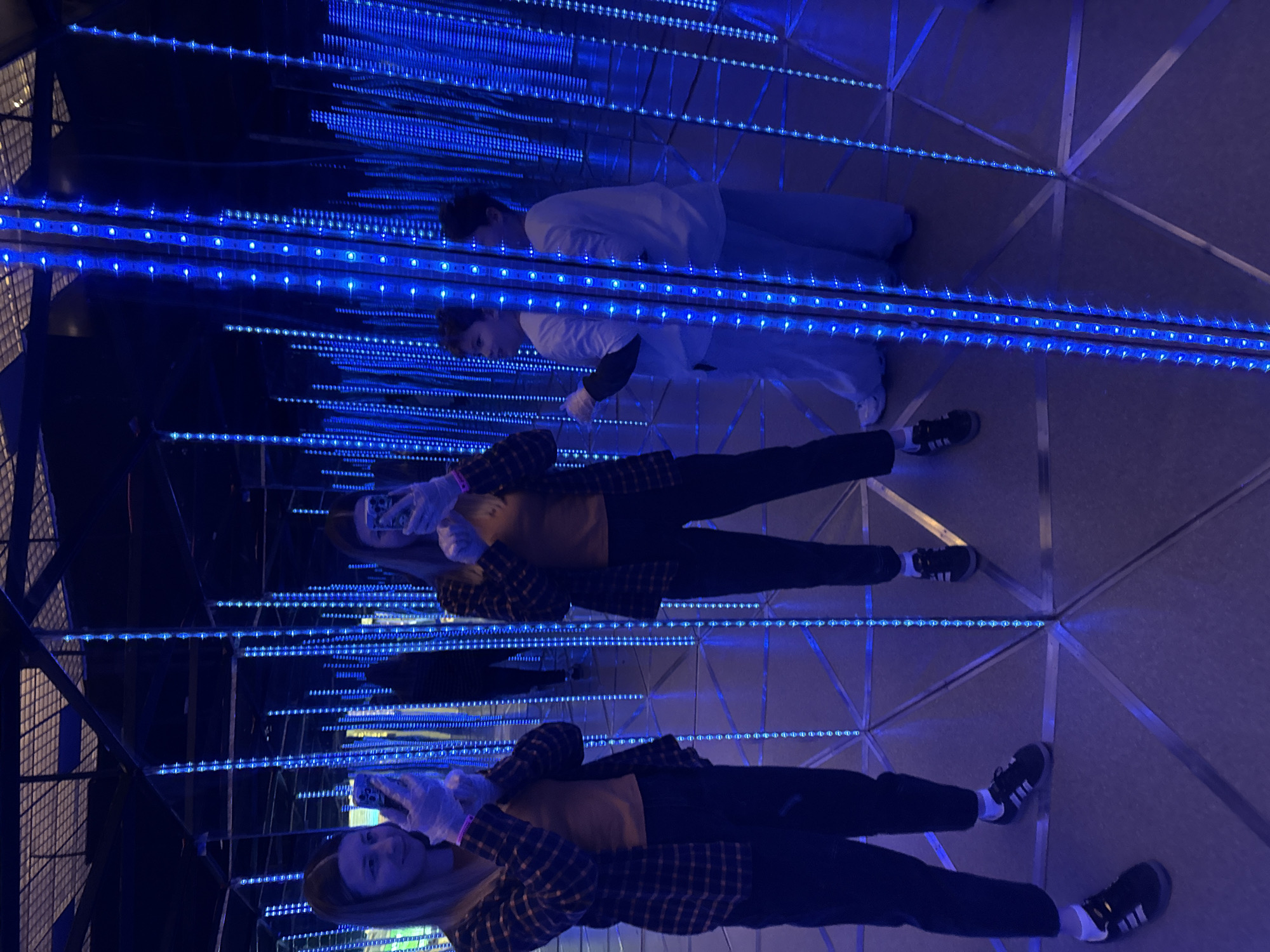 Visitors explore blue LED infinity mirror maze at Moscow museum