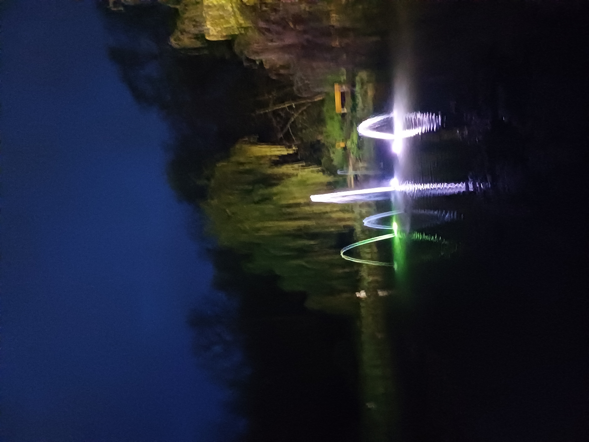 Nighttime water scene captured with colorful light installations