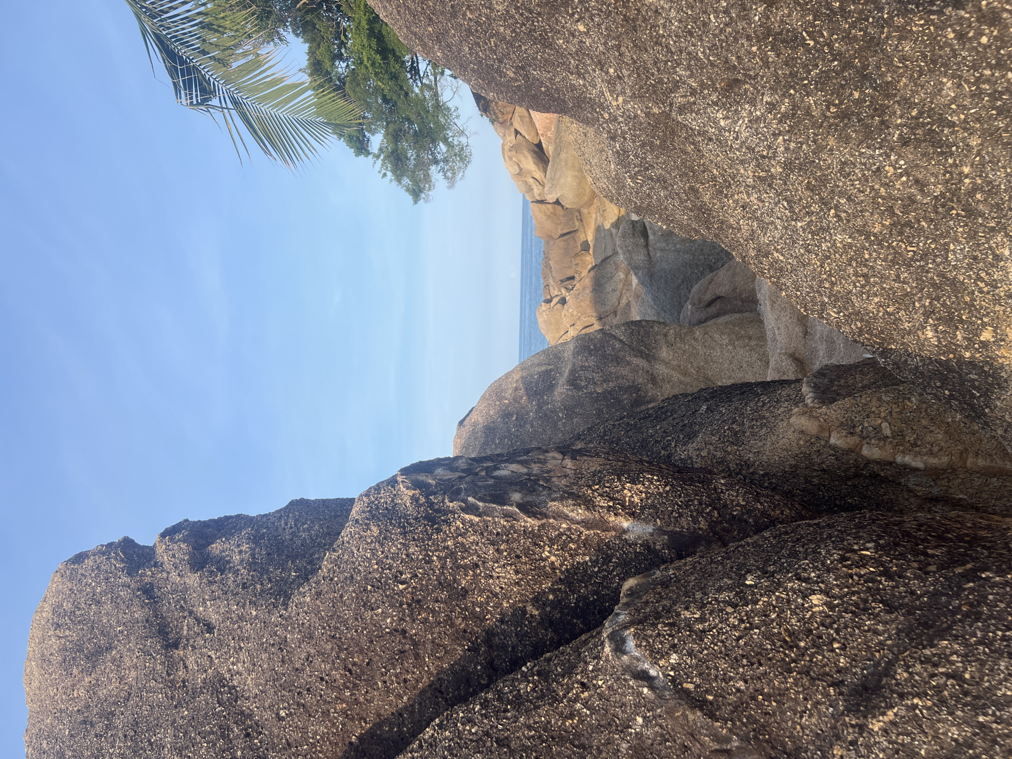Hibiscus flowers and granite boulders on a Ko Samui beach
