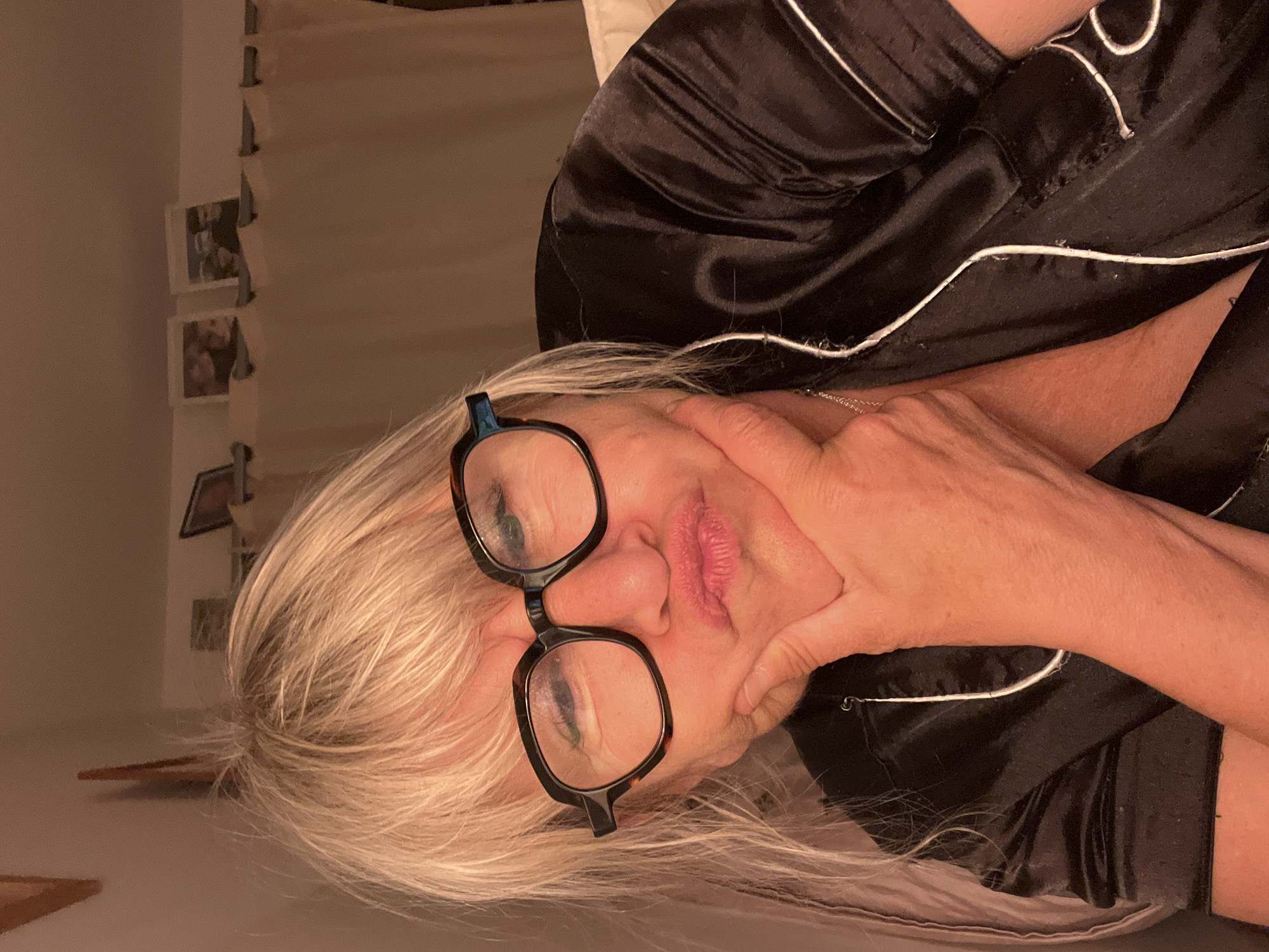 Woman in silk pajamas captured in bedroom moments