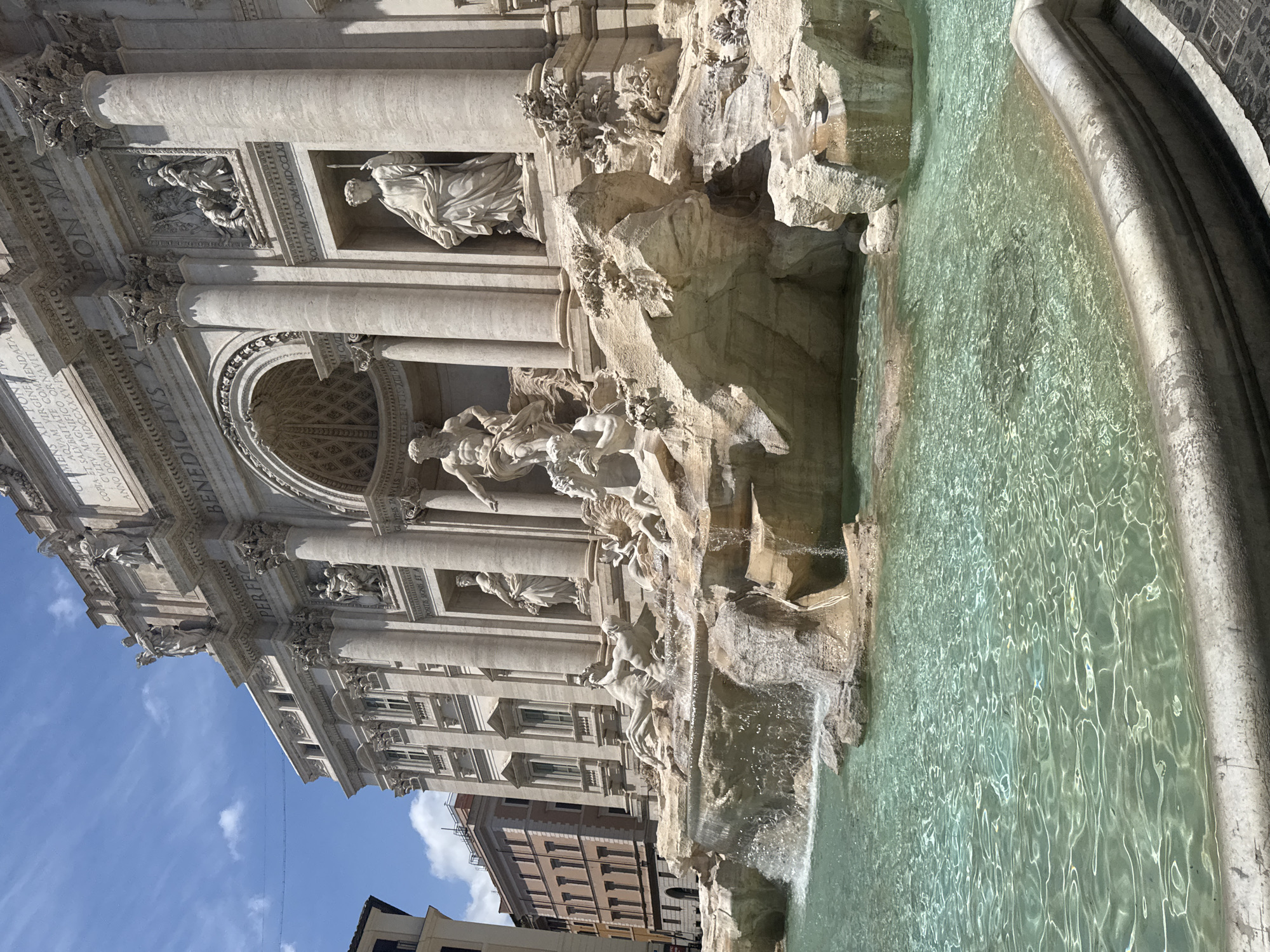 Tourists gather at Rome's Trevi Fountain on sunny day
