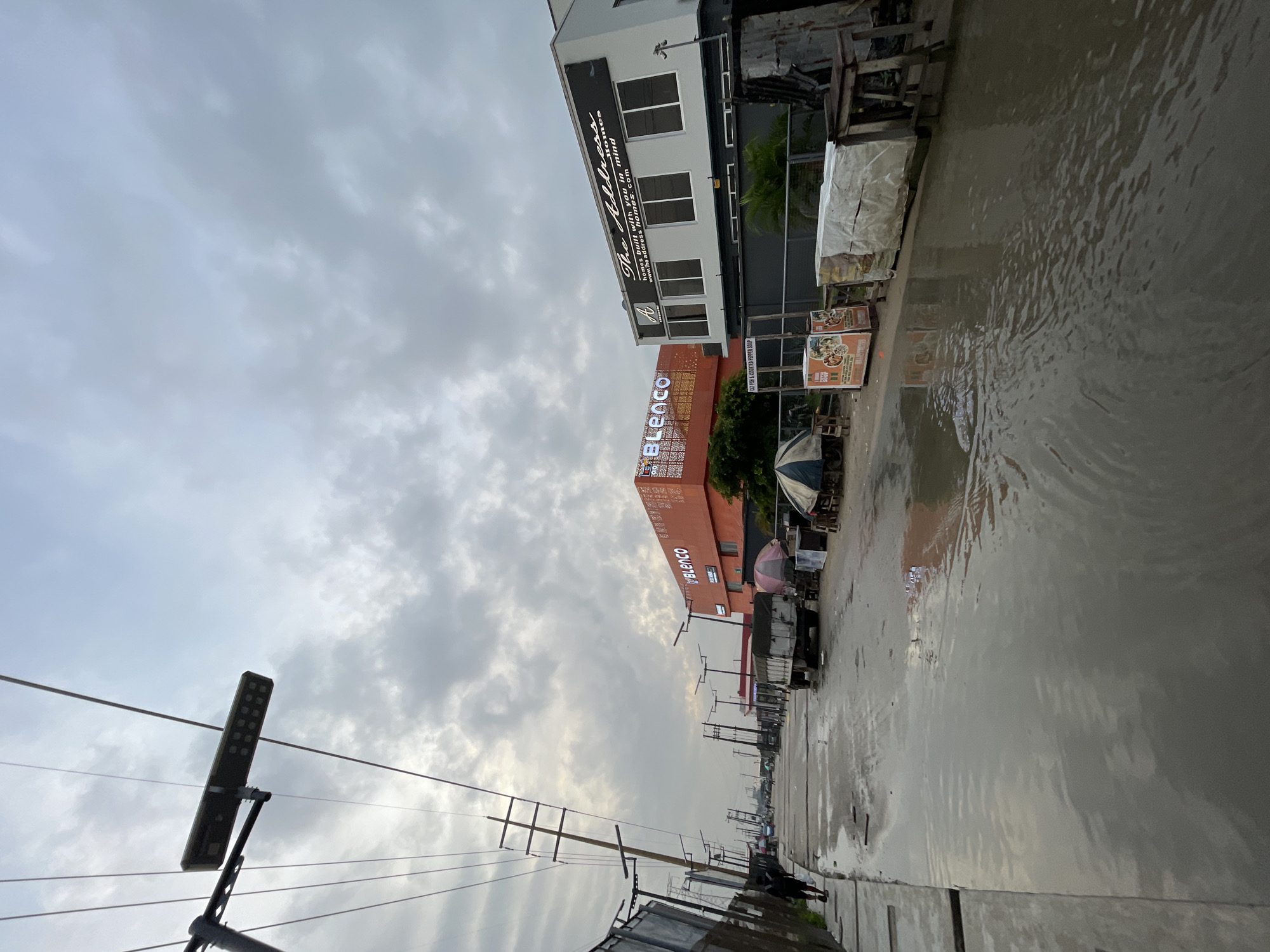 Wet morning streets and daily life in Igboefon, Lagos