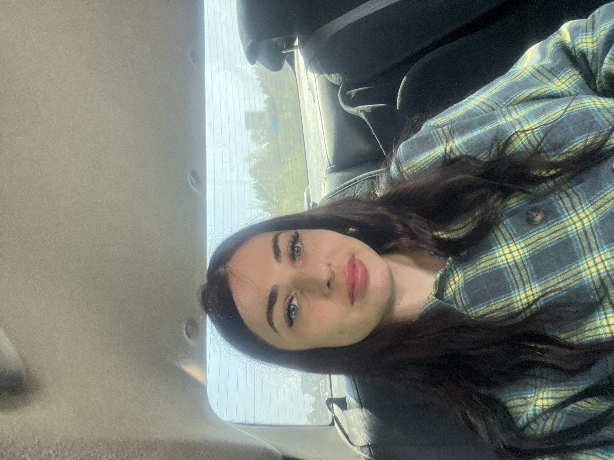 Woman photographed in car wearing ripped jeans in Chaikovsky