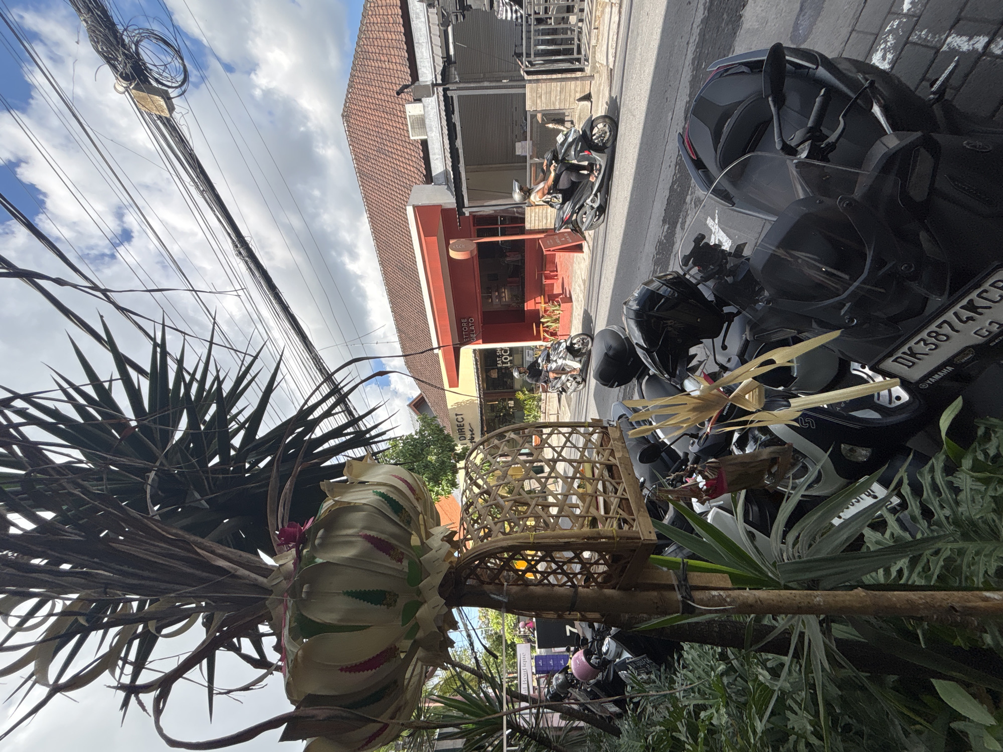 North Kuta street life: cafes, shrines, and scooters on a cloudy morning