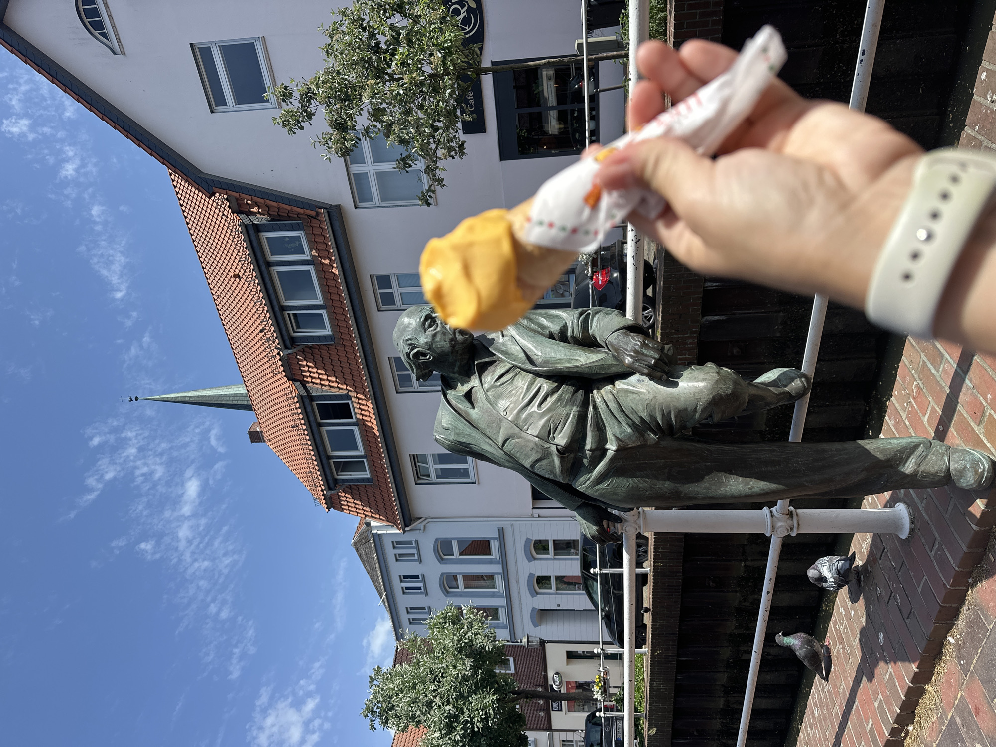 Playful ice cream offering to bronze statue in Buxtehude