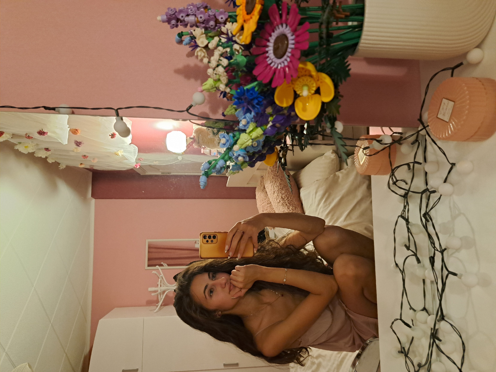 Woman takes selfies, colorful flowers and dramatic sky captured