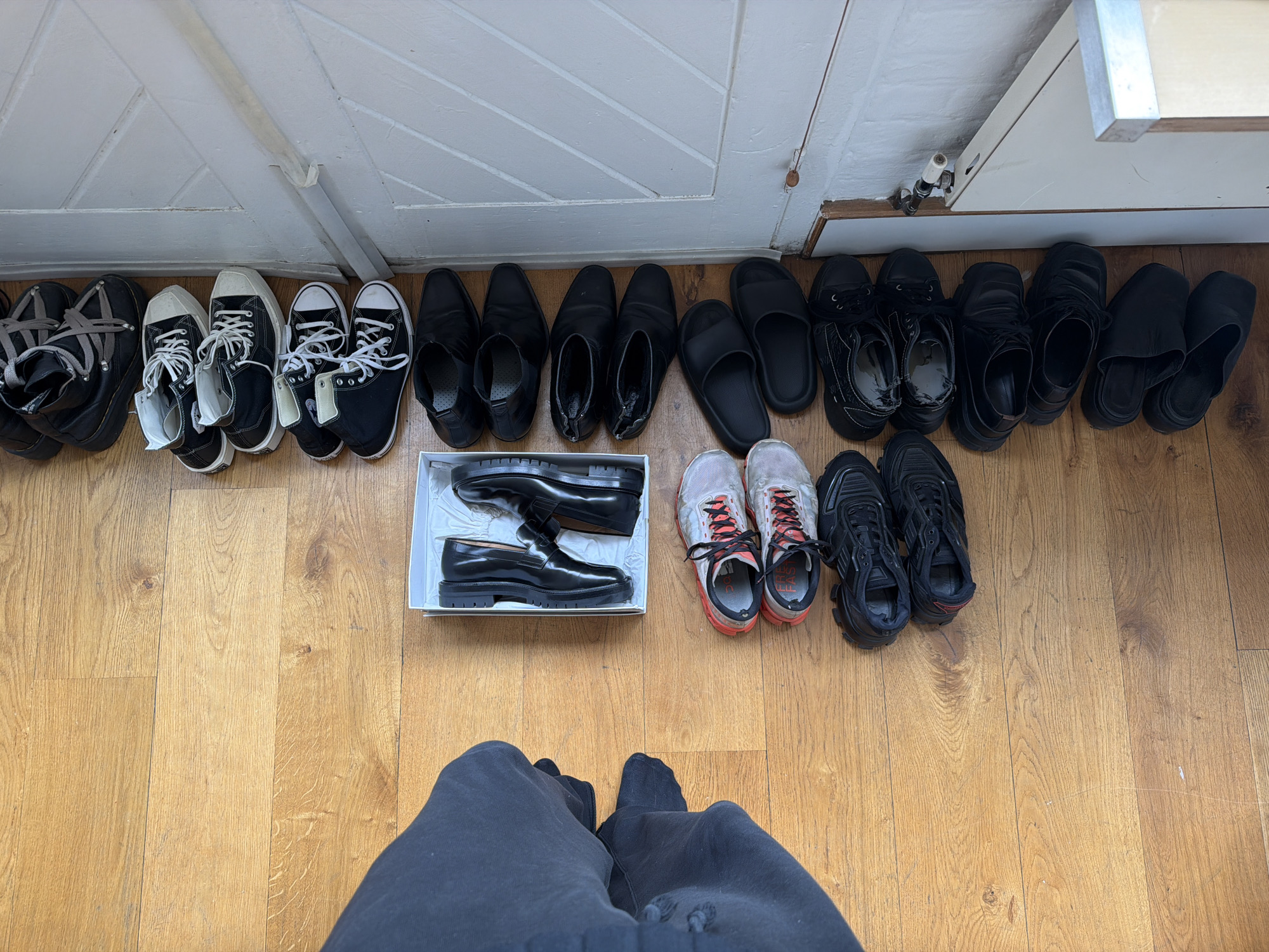 London residential interior documented showing wooden floors, white door