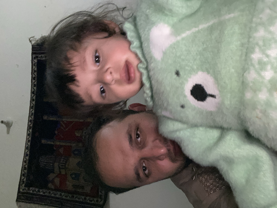 Father and child share tender moments in Kandahar home