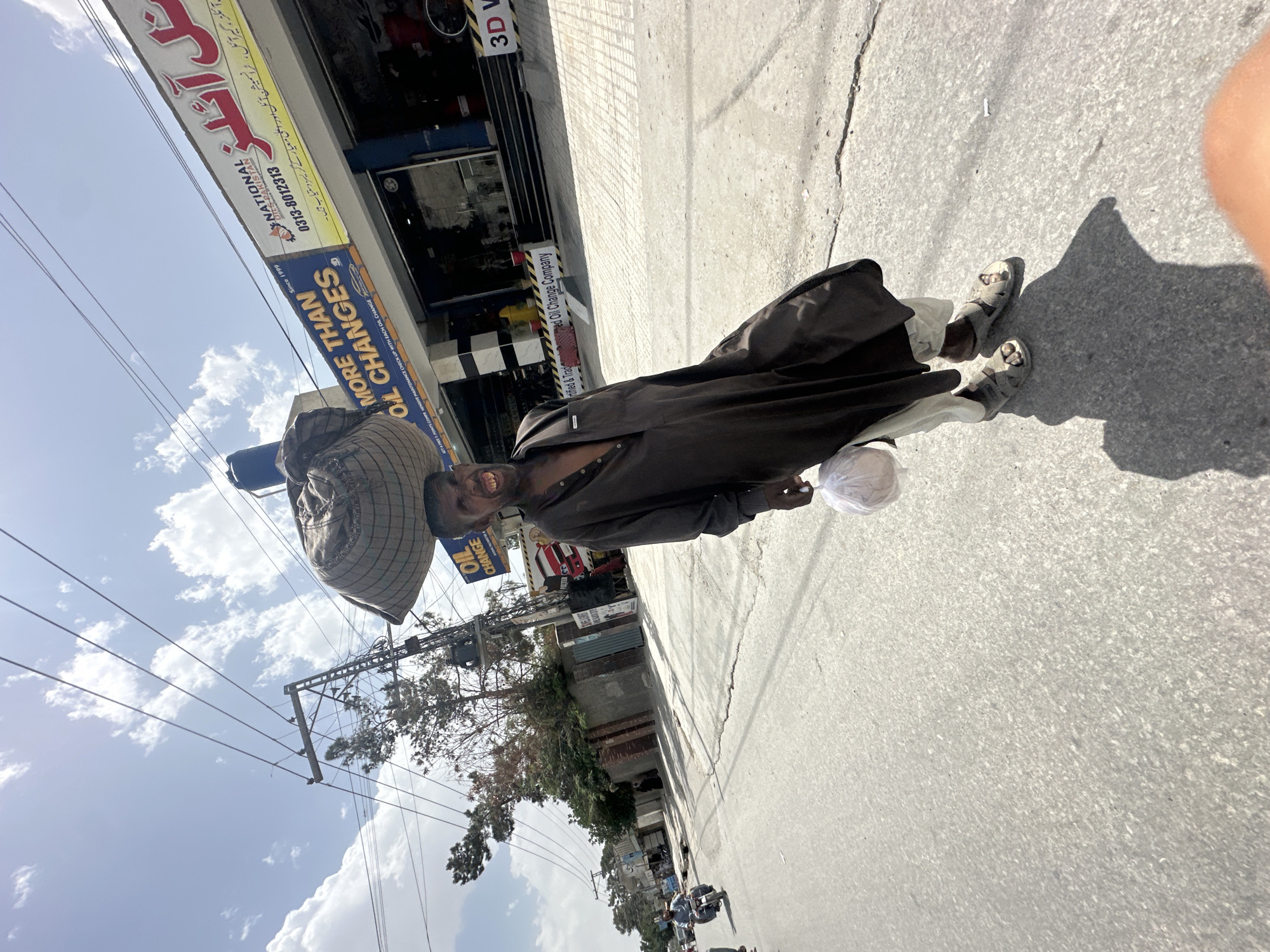 Man with traditional basket observed on Quetta sidewalk