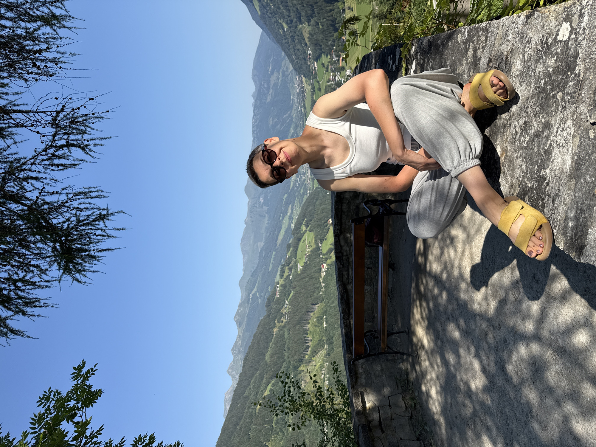 Relaxing on a stone ledge with Austrian mountain valley views