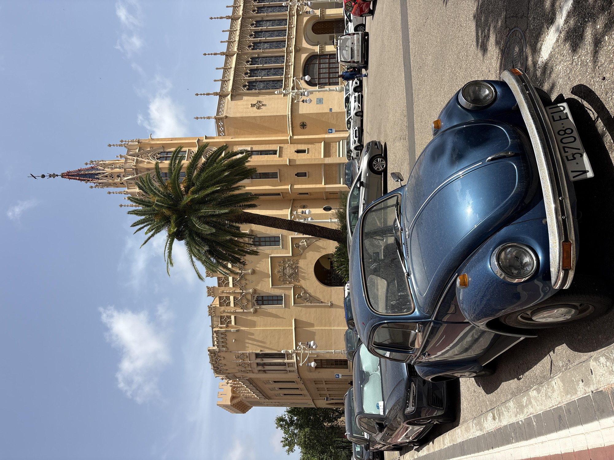 Blue Beetle parked outside Valencia's neo-Gothic landmark
