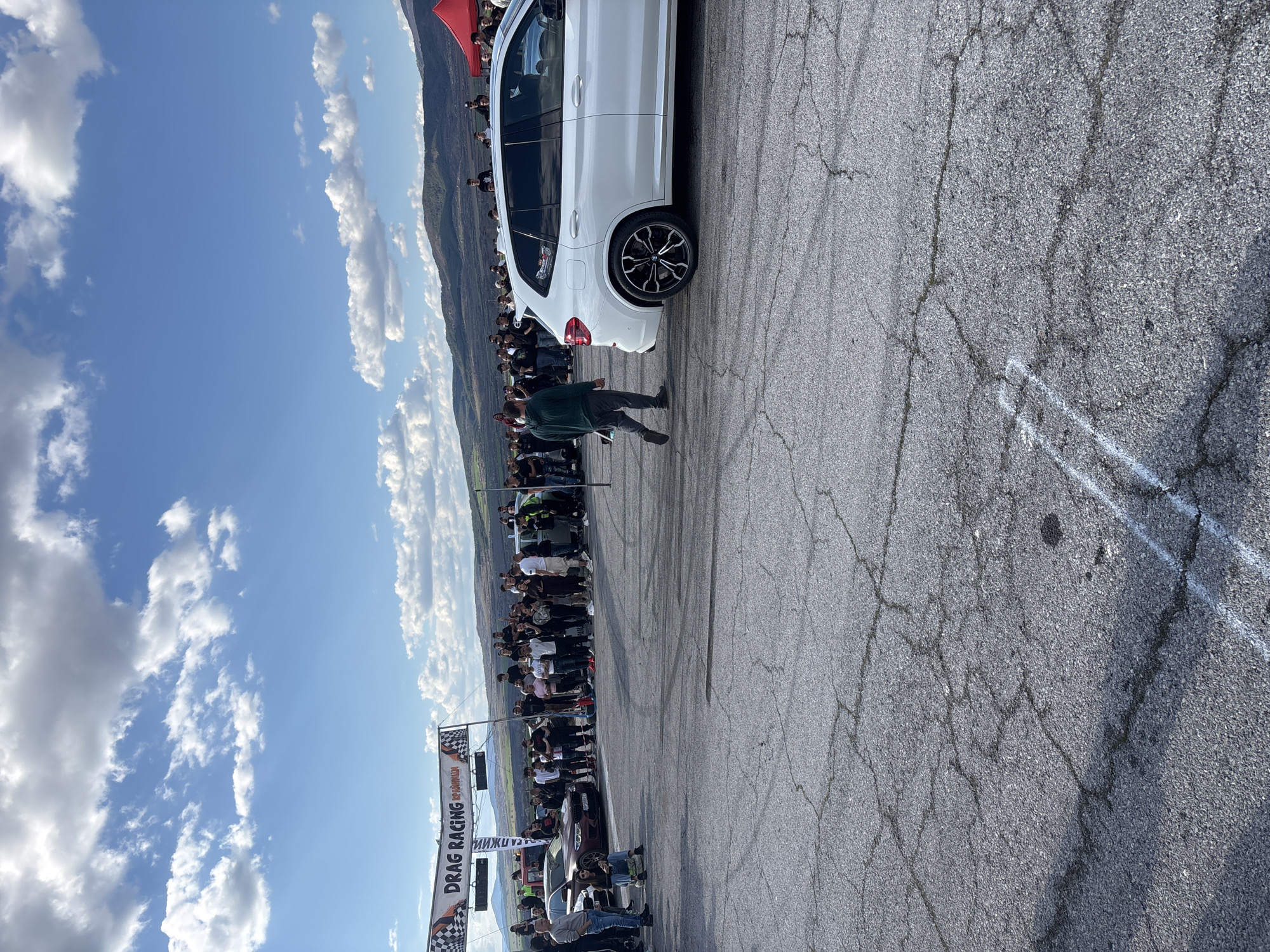 Crowd gathers on tire stacks to watch roadway event